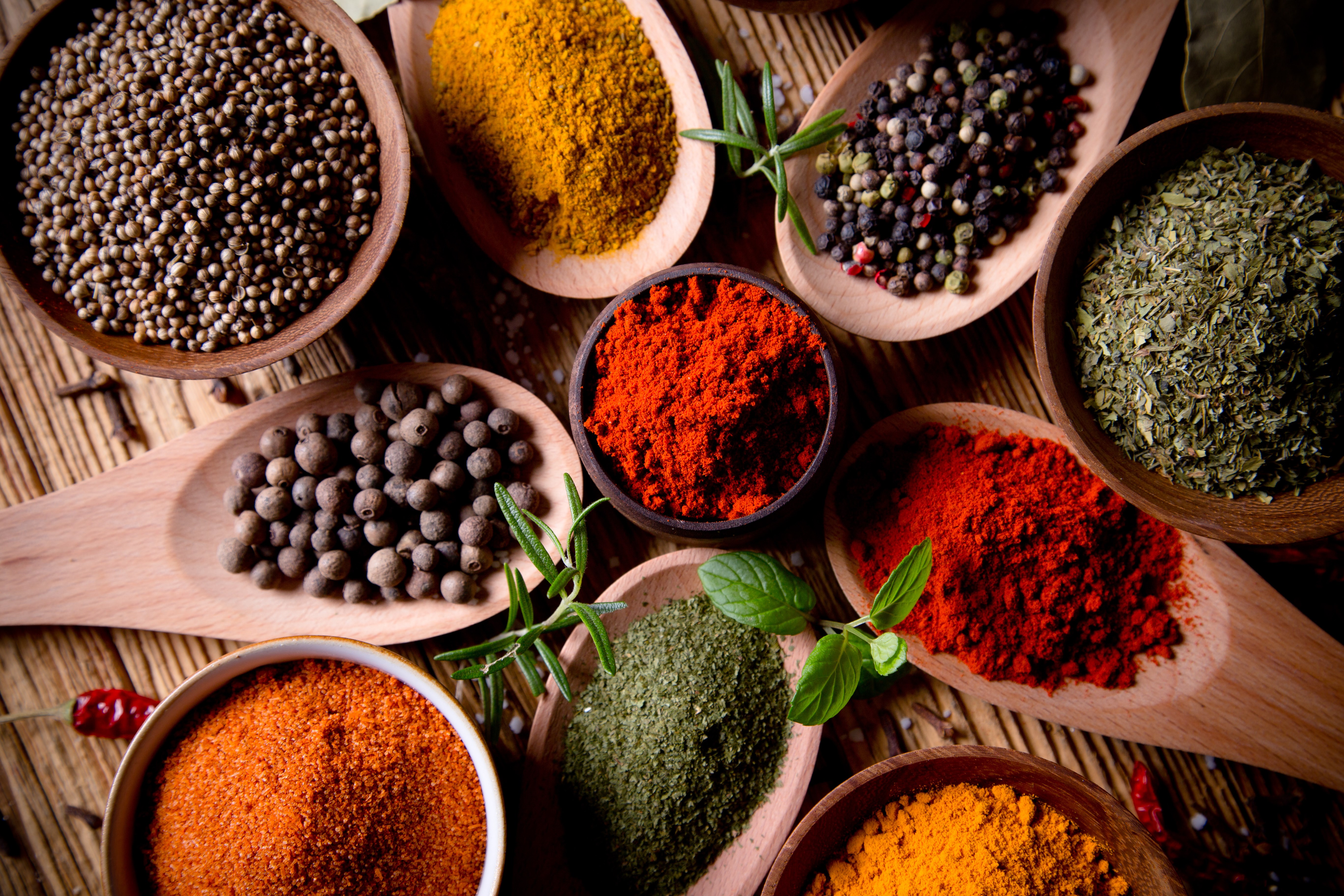 Colorful Variety of Ground and Whole Spices in Bowls HD Wallpaper