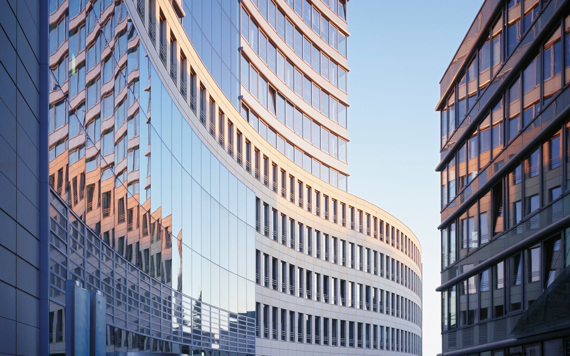 Modern curved glass office buildings HD Wallpaper