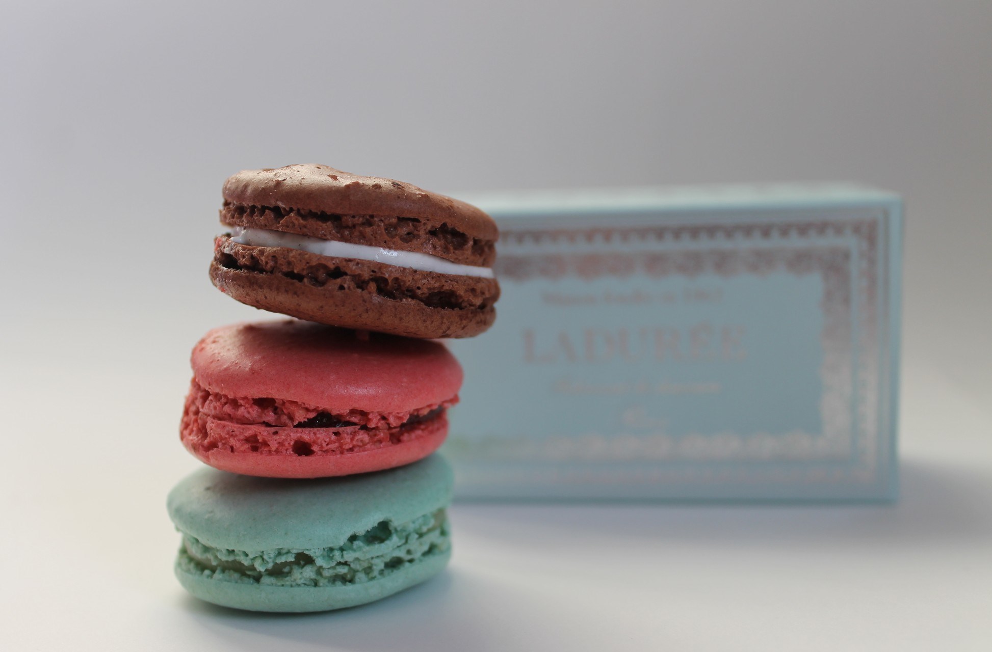 Stack of Laduree macarons with box HD Wallpaper