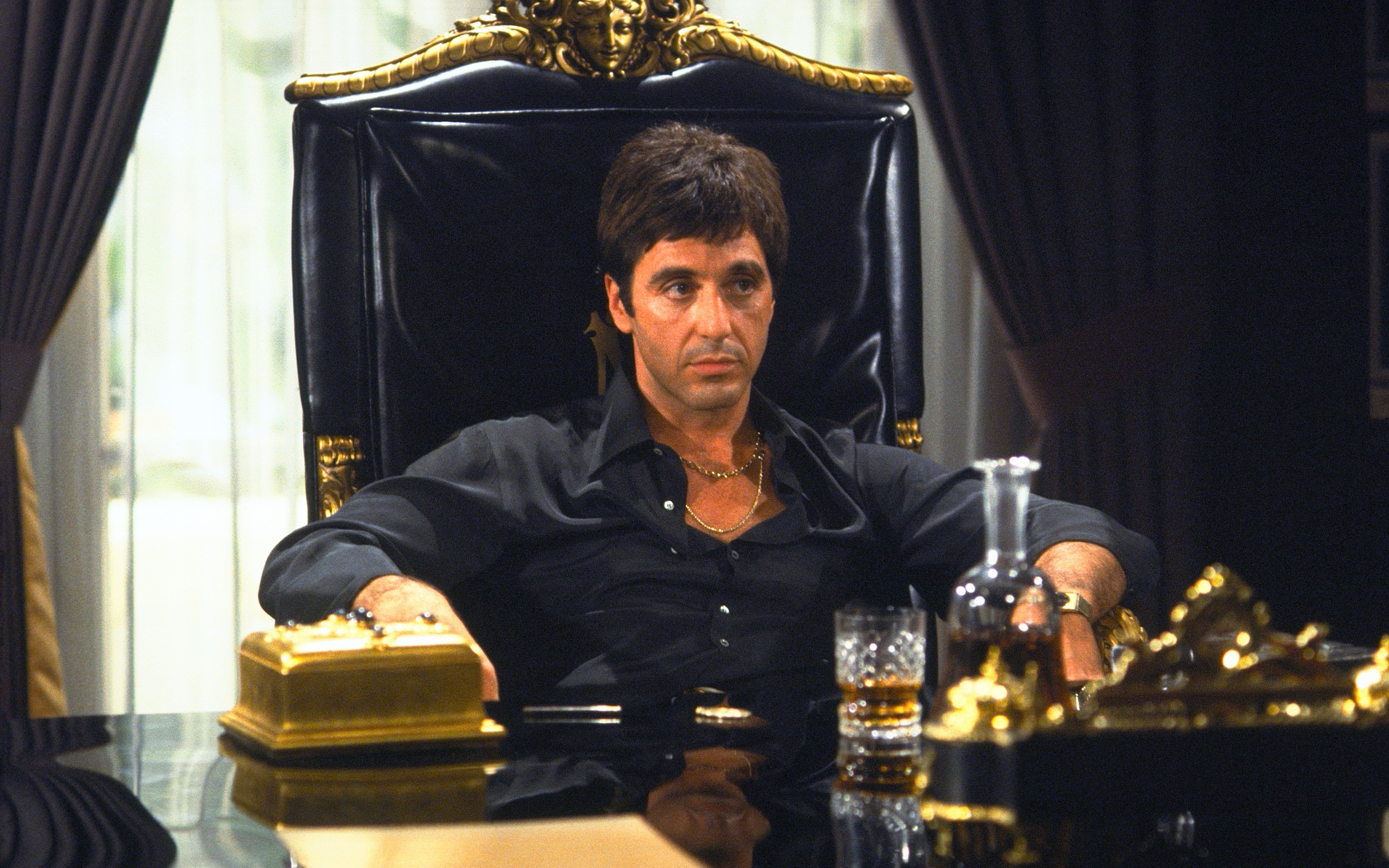Tony Montana from Scarface sitting in a chair HD Wallpaper