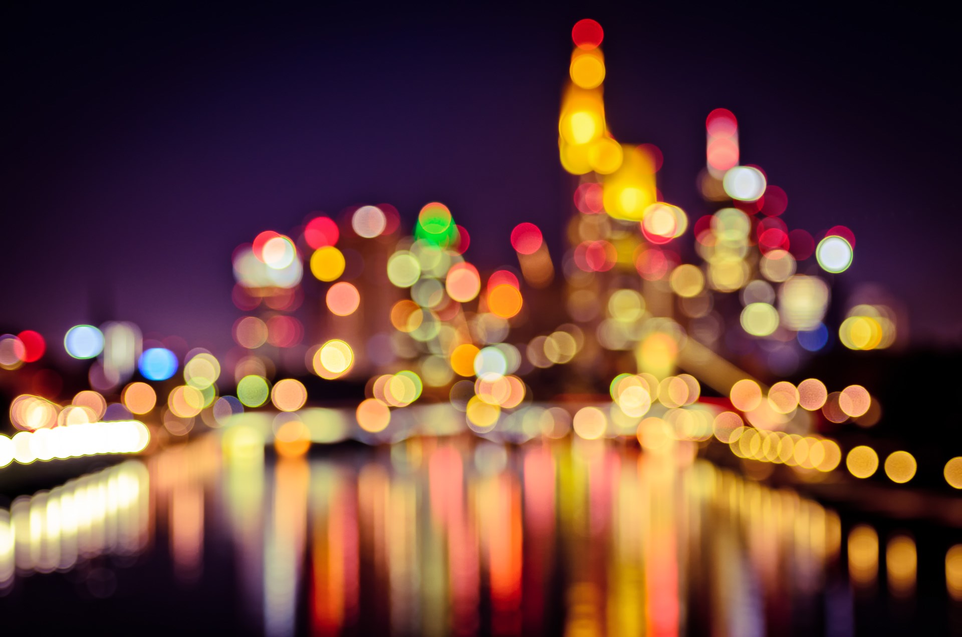 Bokeh lights of a city skyline at night HD Wallpaper
