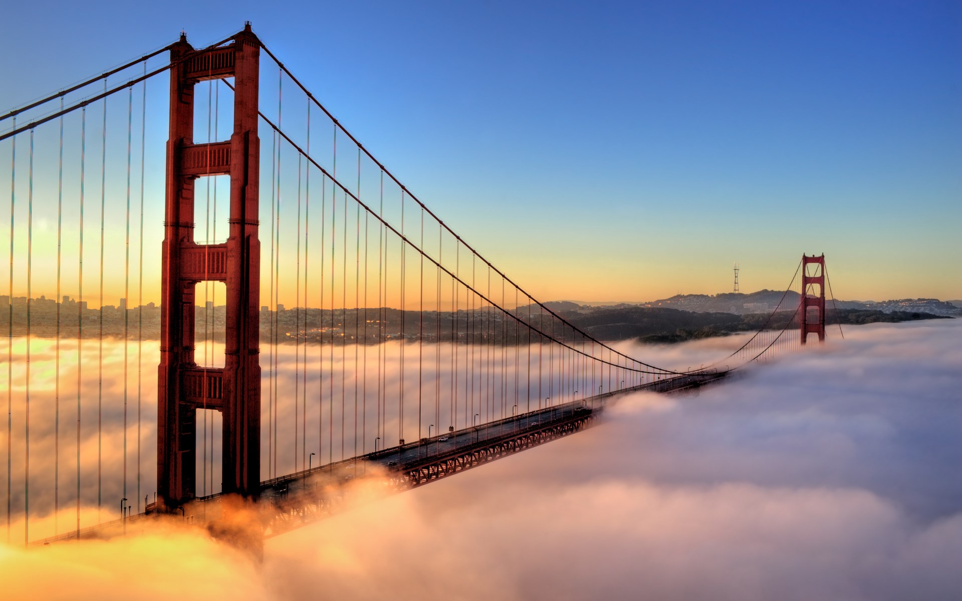 Golden Gate Bridge emerging from fog at sunrise HD Wallpaper