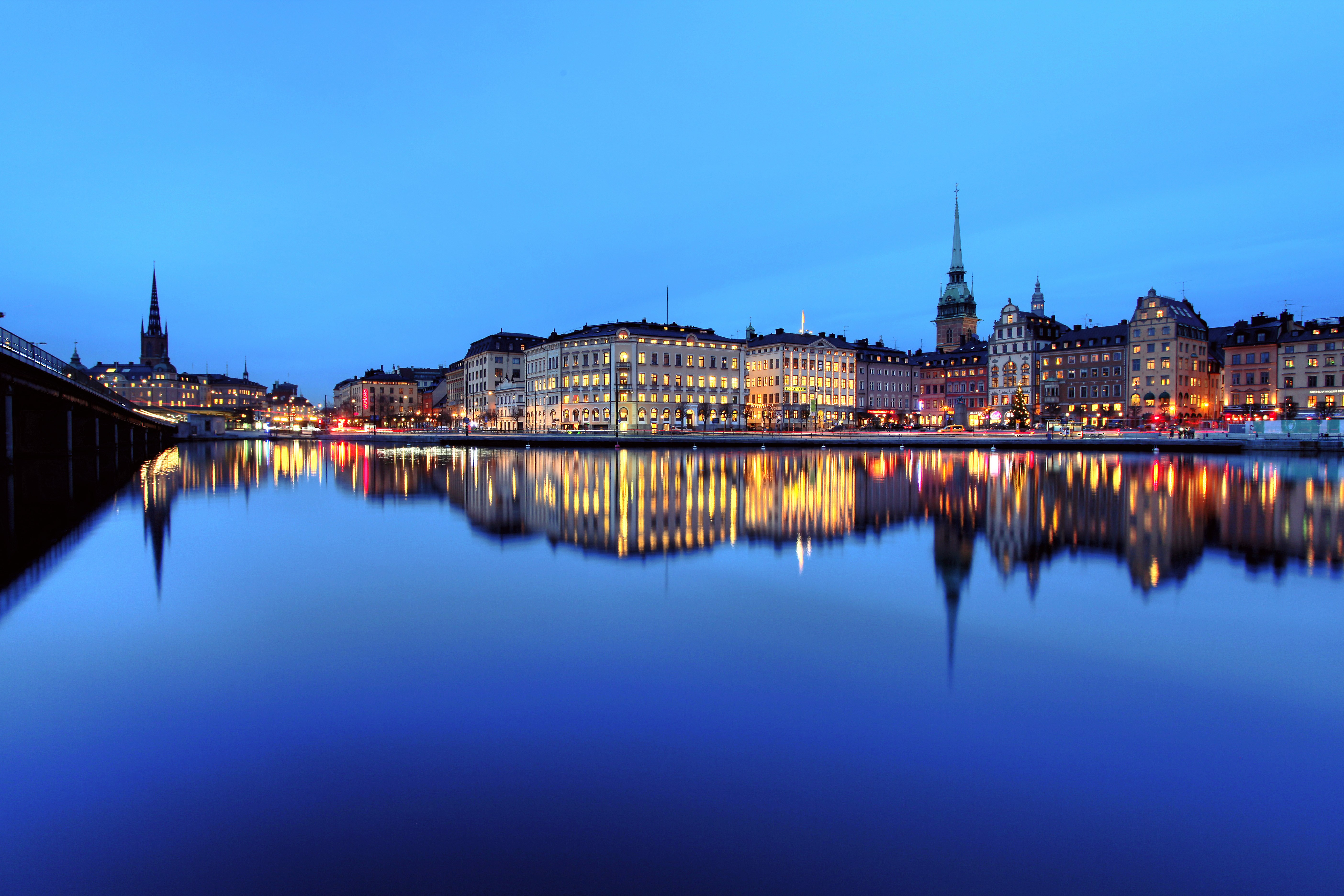 Stockholm cityscape with water reflections at dusk HD Wallpaper