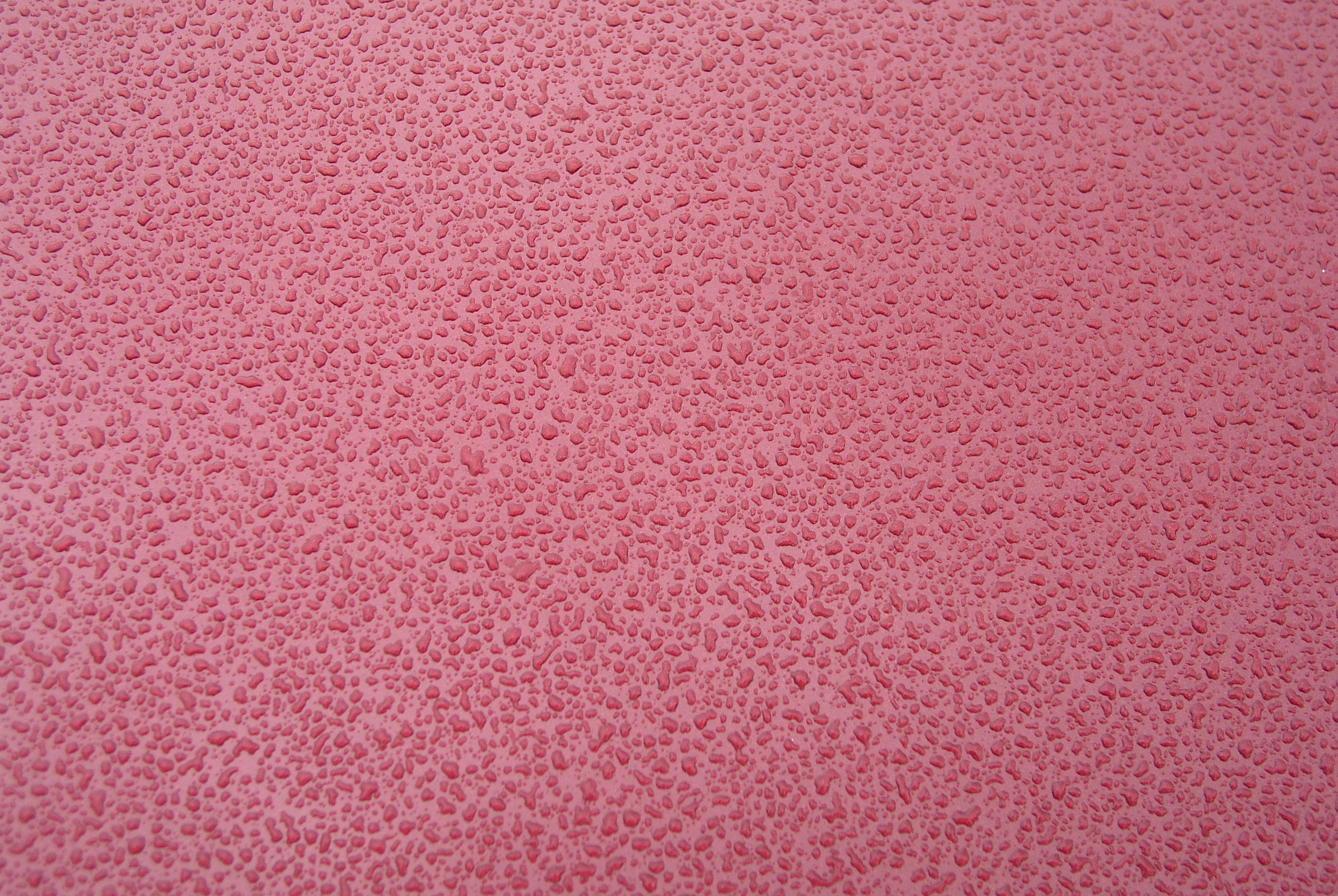 Water drops on a pink surface HD Wallpaper