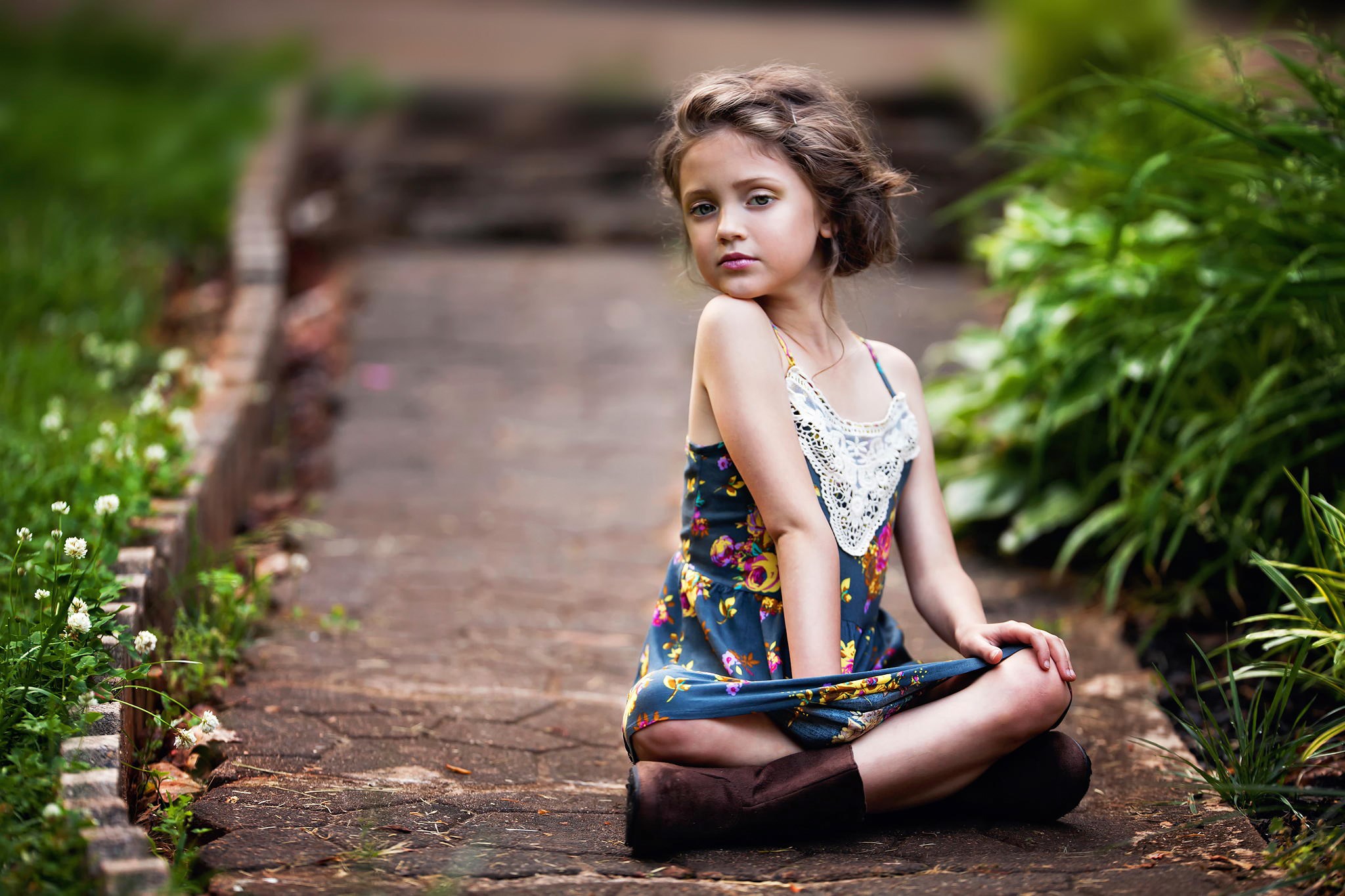 Young girl sitting on a path HD Wallpaper