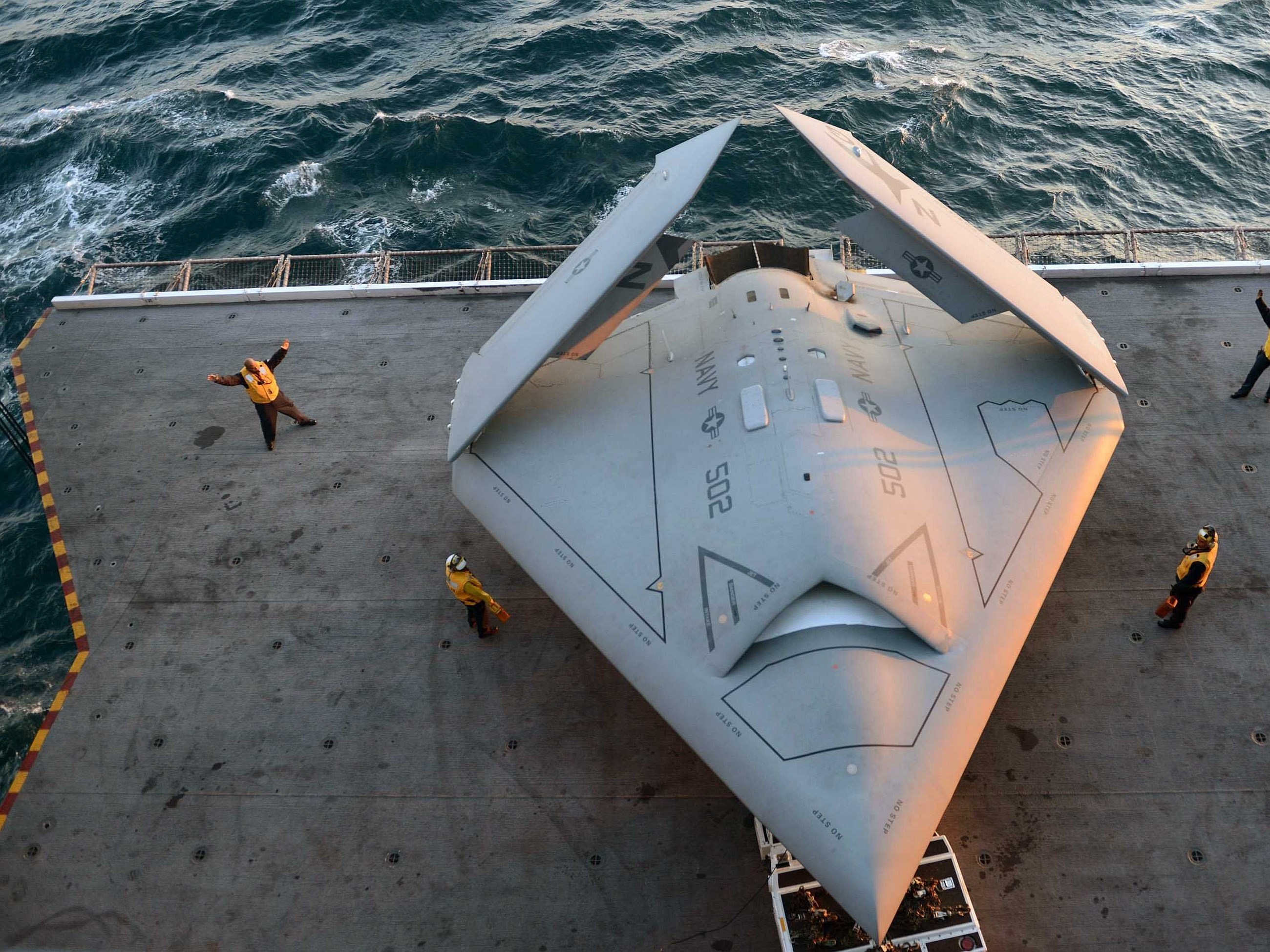 Northrop Grumman X-47B drone on aircraft carrier deck HD Wallpaper