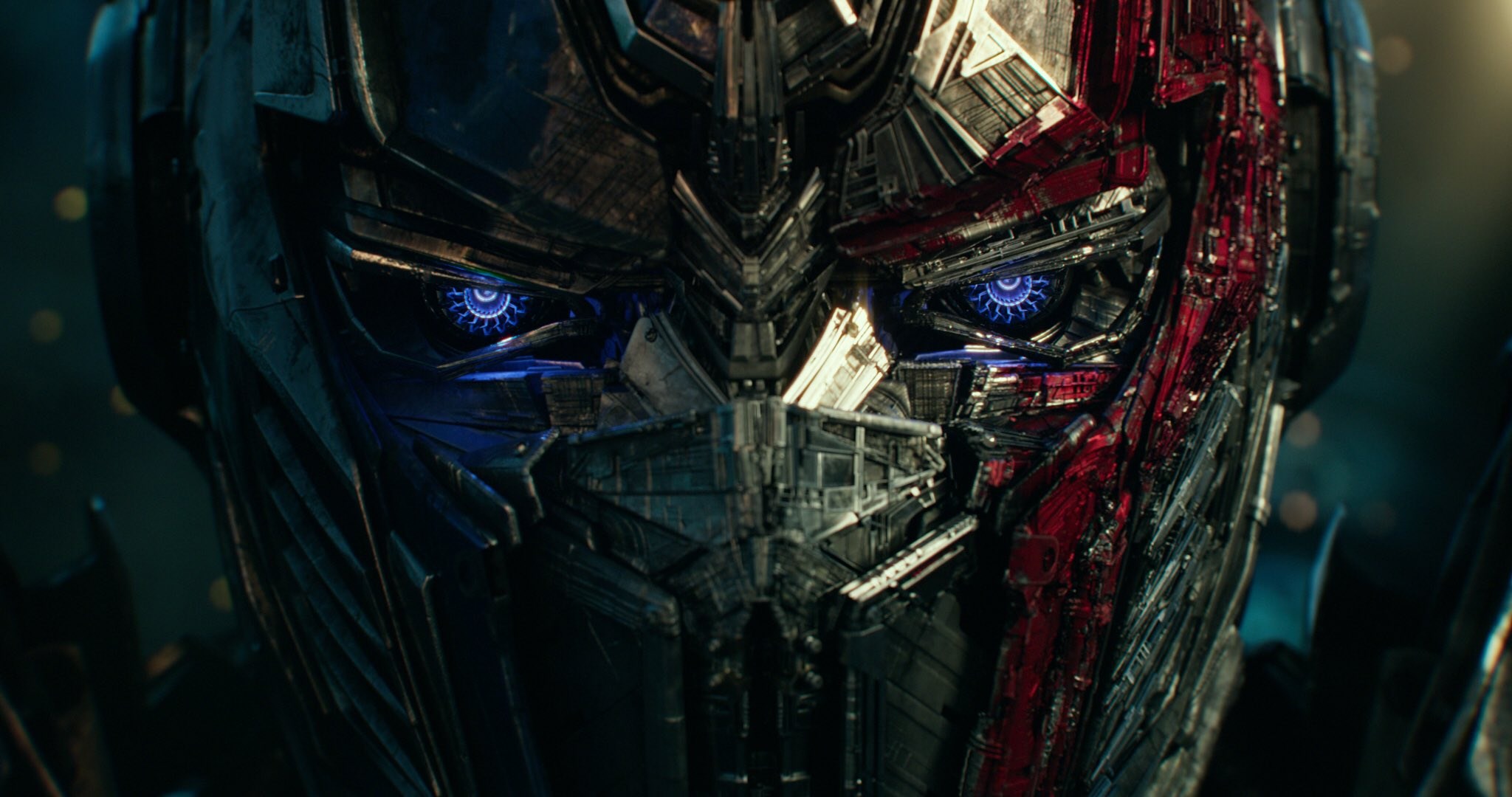 Close-Up of Transformer Robot Face with Blue Eyes HD Wallpaper