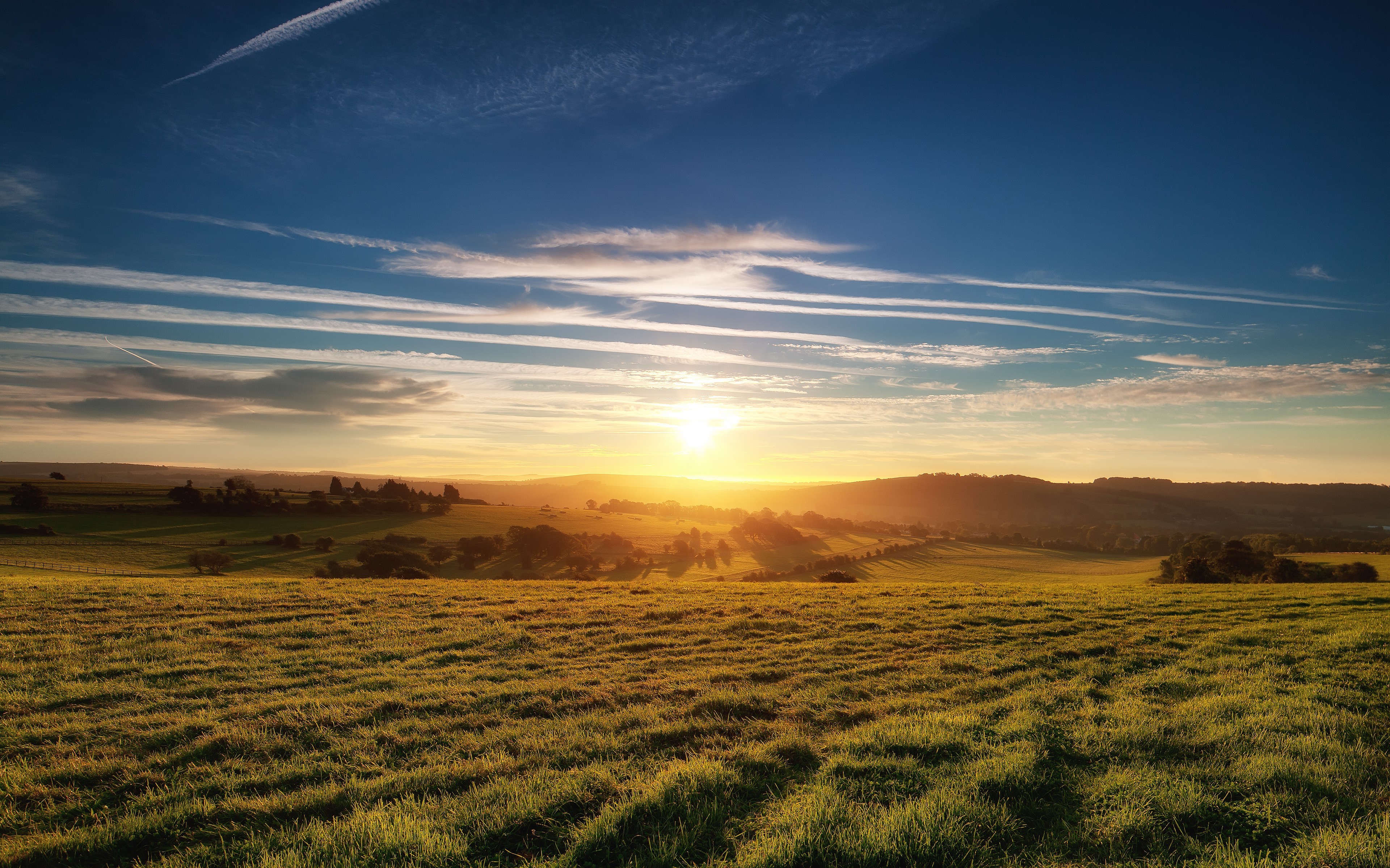 Sunset over rolling hills and fields HD Wallpaper