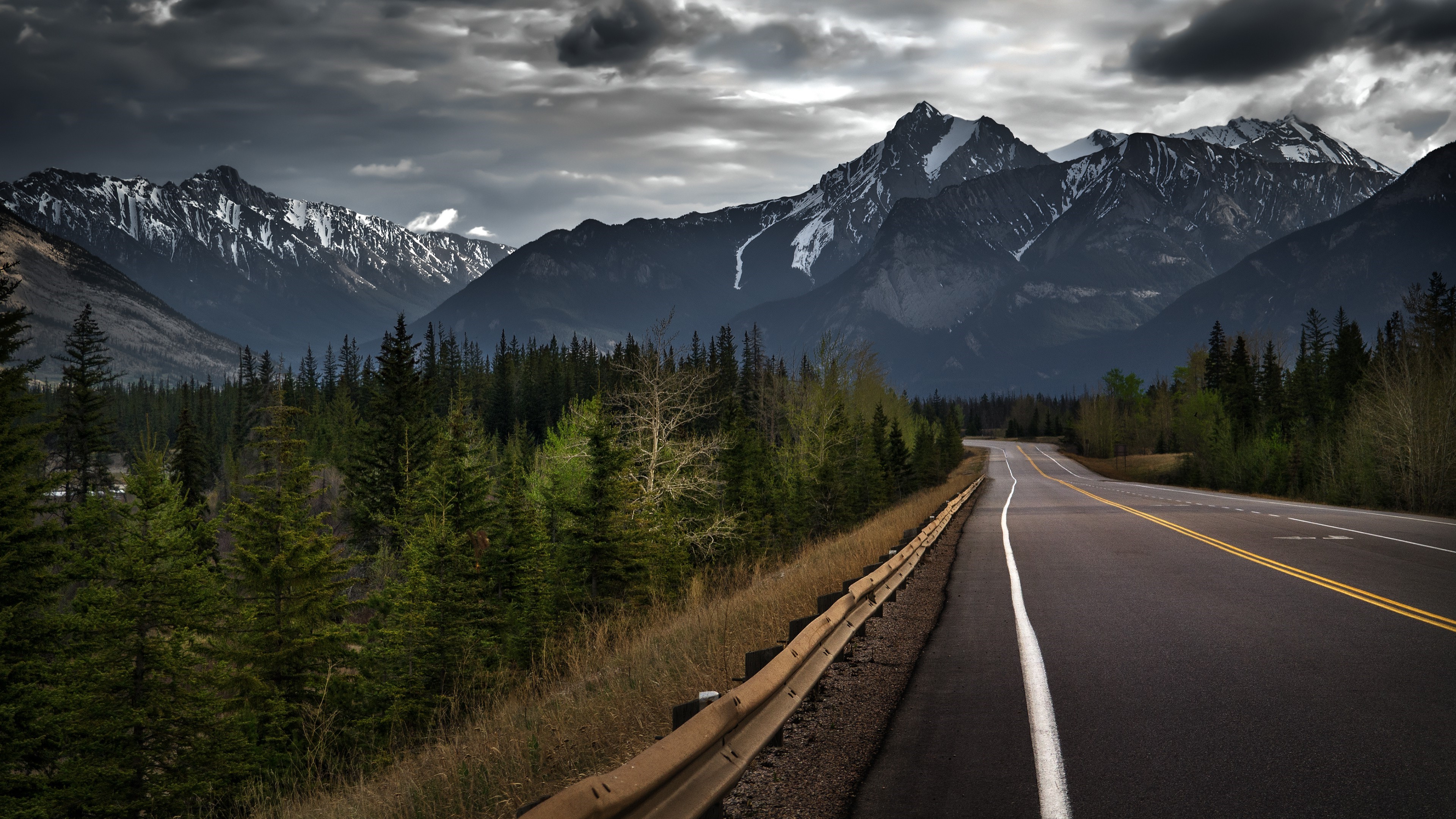 Mountain road with forest and stormy clouds HD Wallpaper