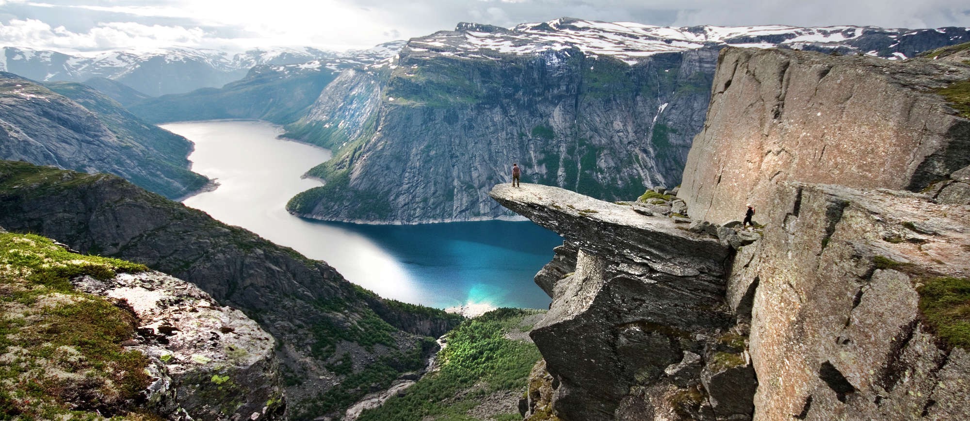 Majestic Rocky Cliff Overlooking Serene Fjord in Norway HD Wallpaper