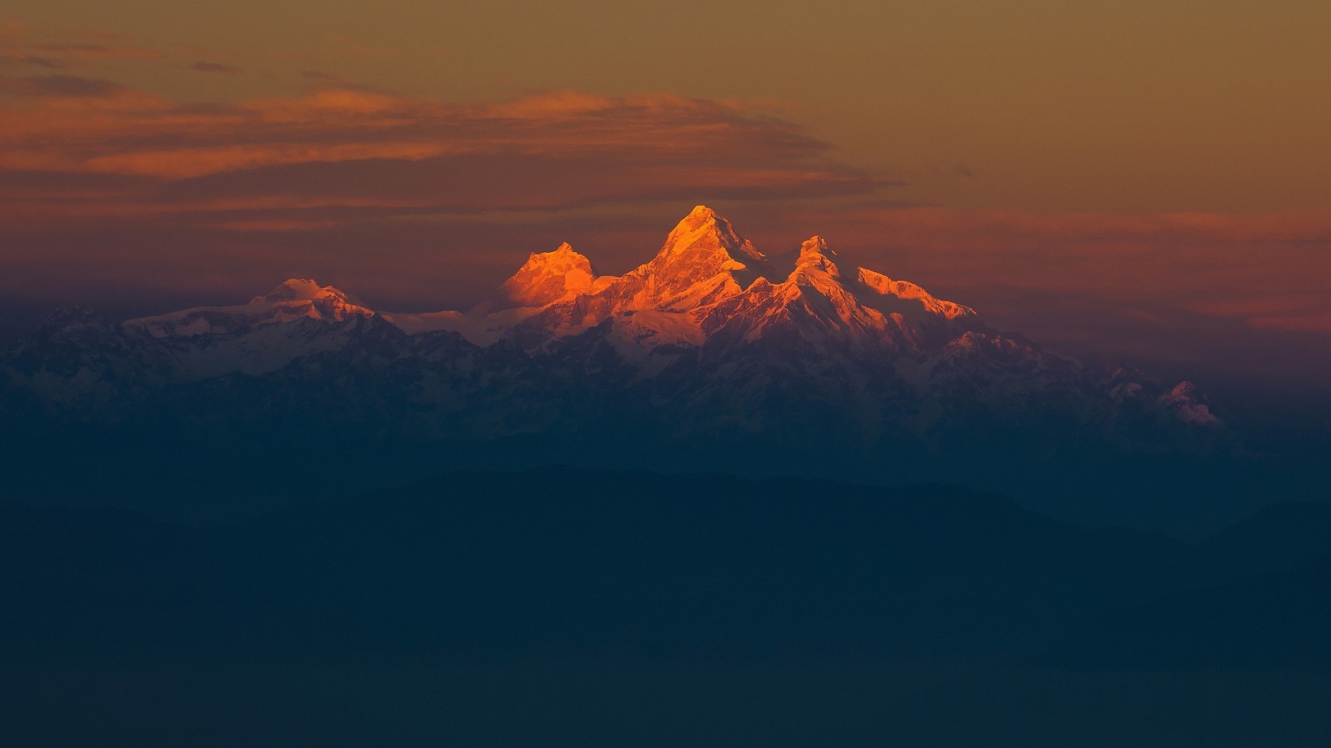 Snowy Himalayan peaks at sunset with orange clouds HD Wallpaper
