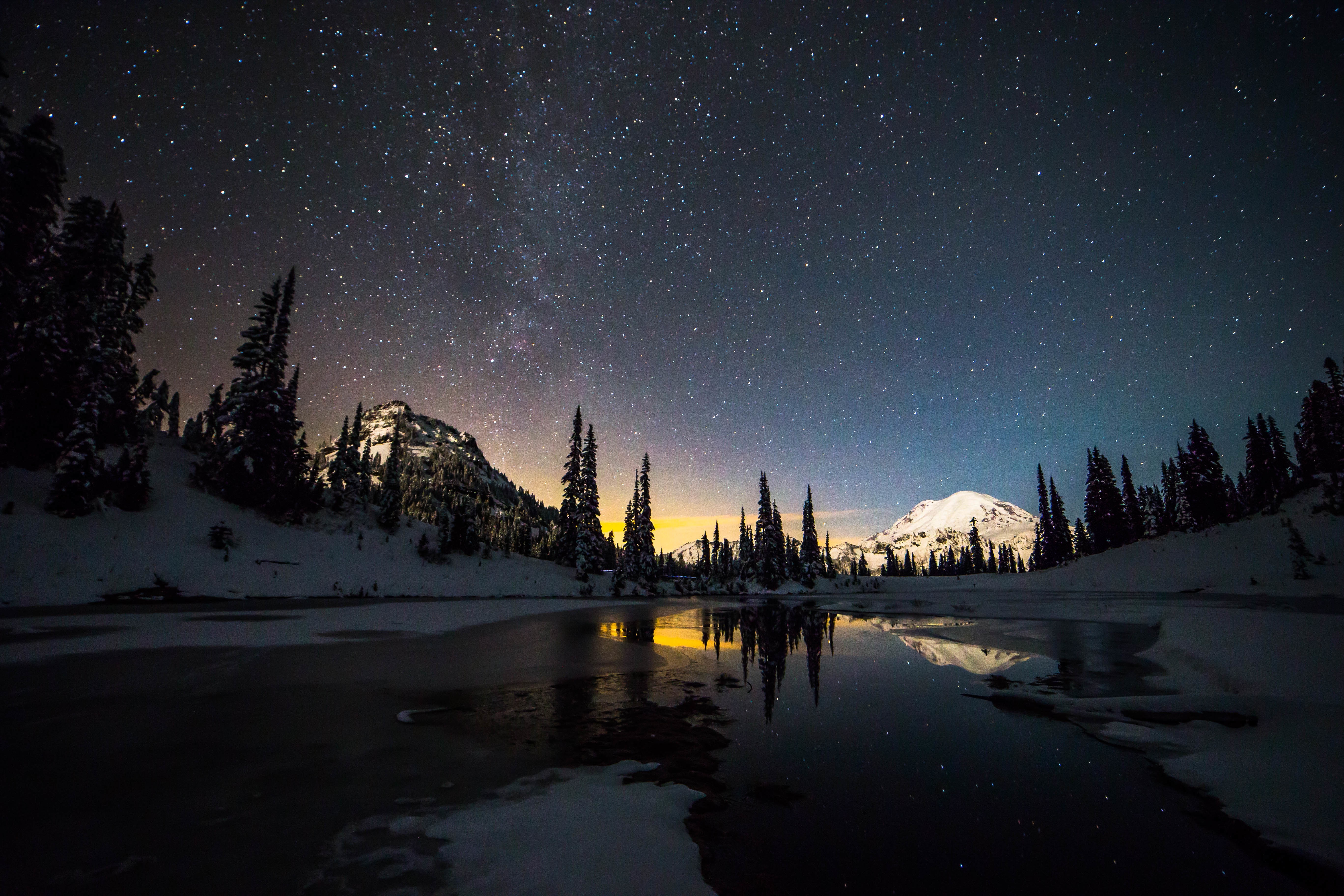 Snowy mountains and lake under starry night sky HD Wallpaper