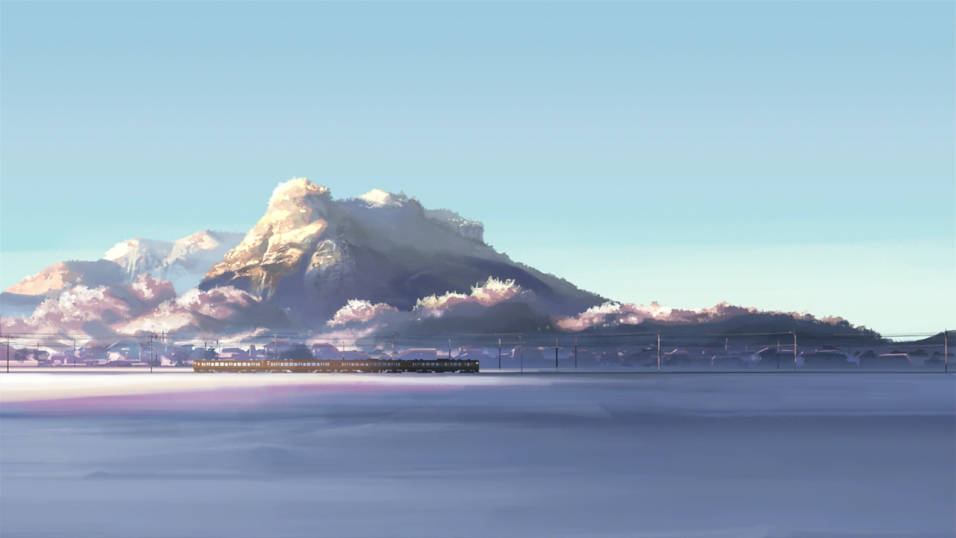 Train passing through a snowy landscape with mountains HD Wallpaper
