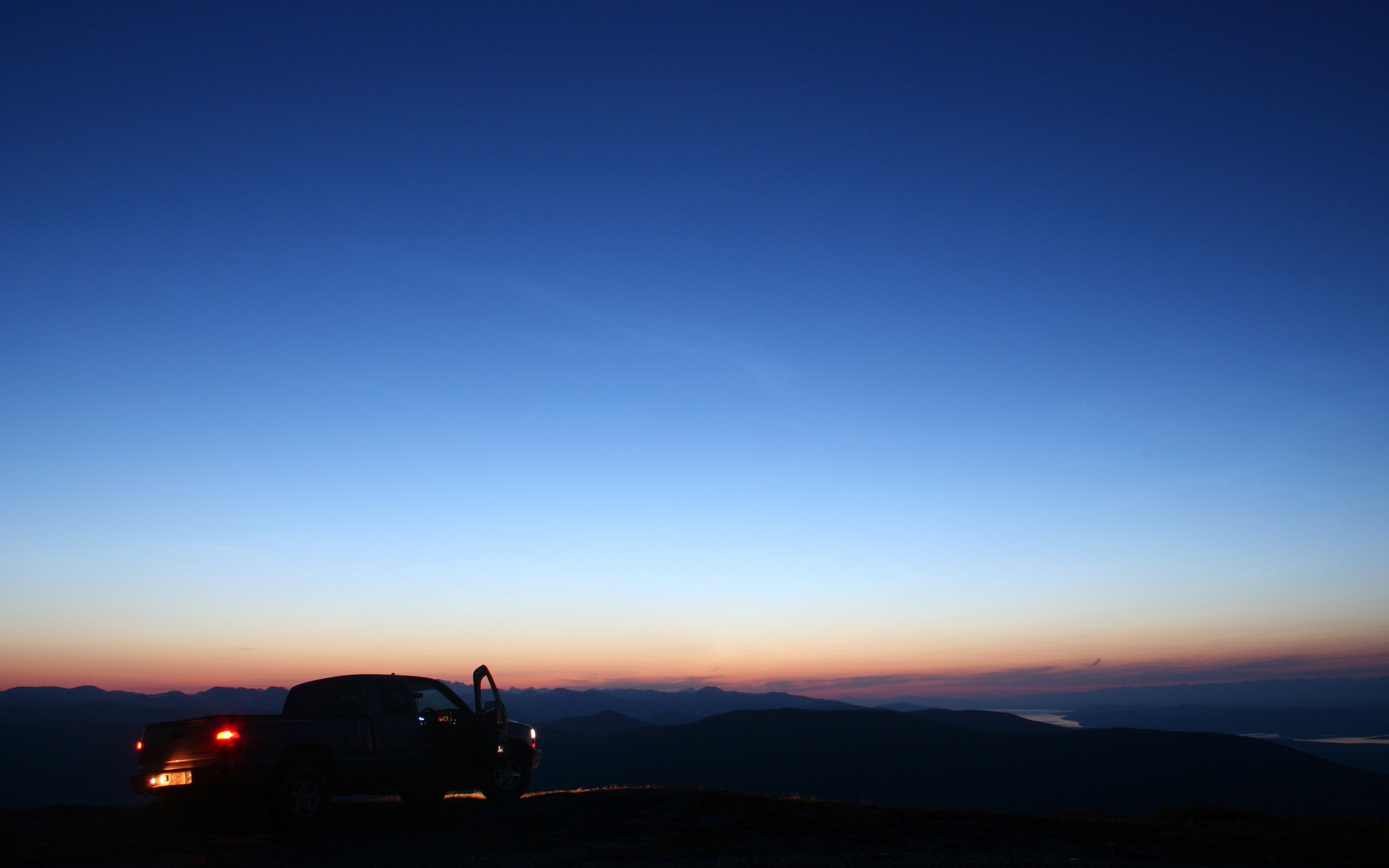 Pickup truck at sunset with mountain landscape HD Wallpaper