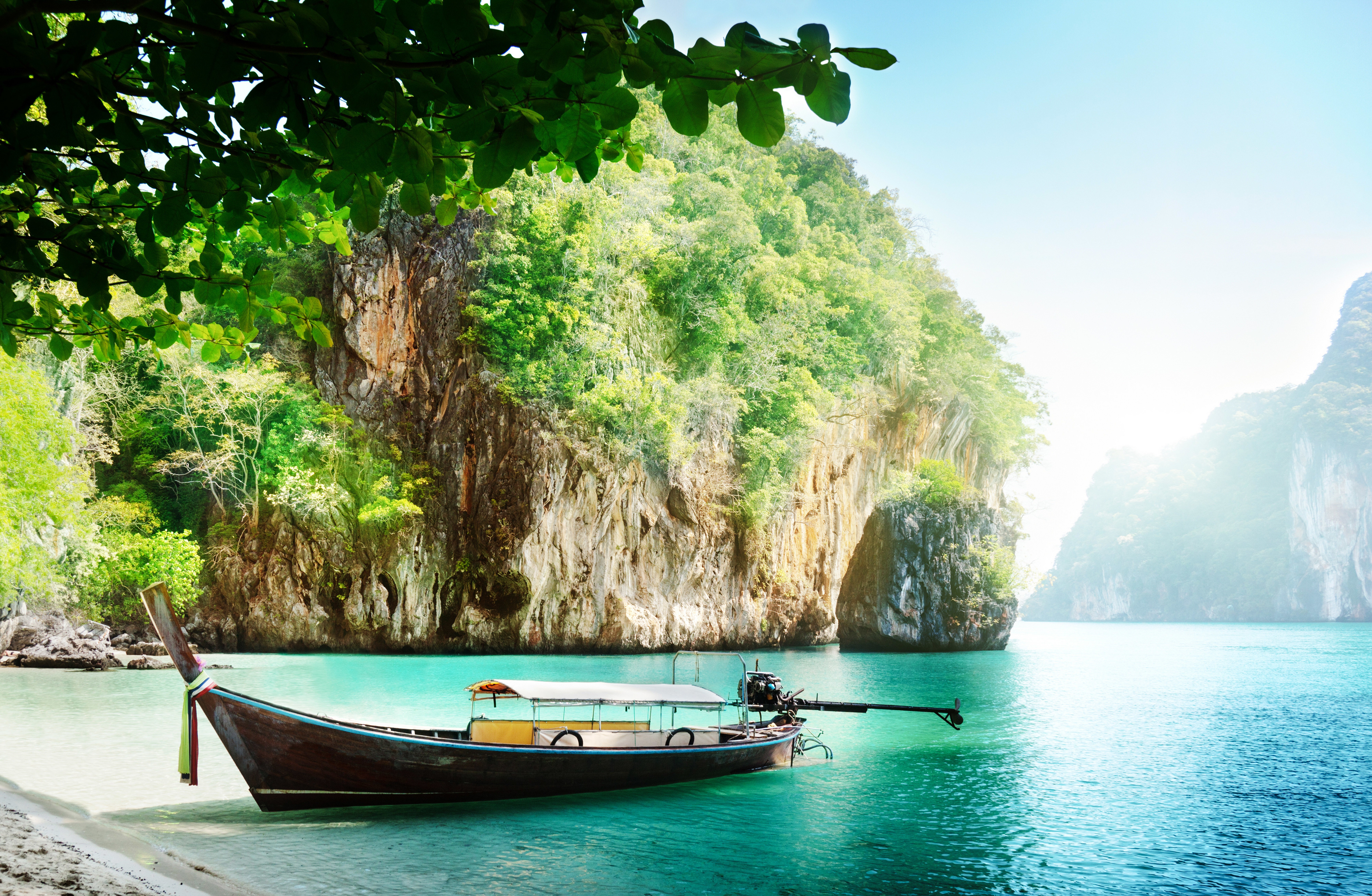 Longtail boat on a tropical beach with limestone cliffs HD Wallpaper
