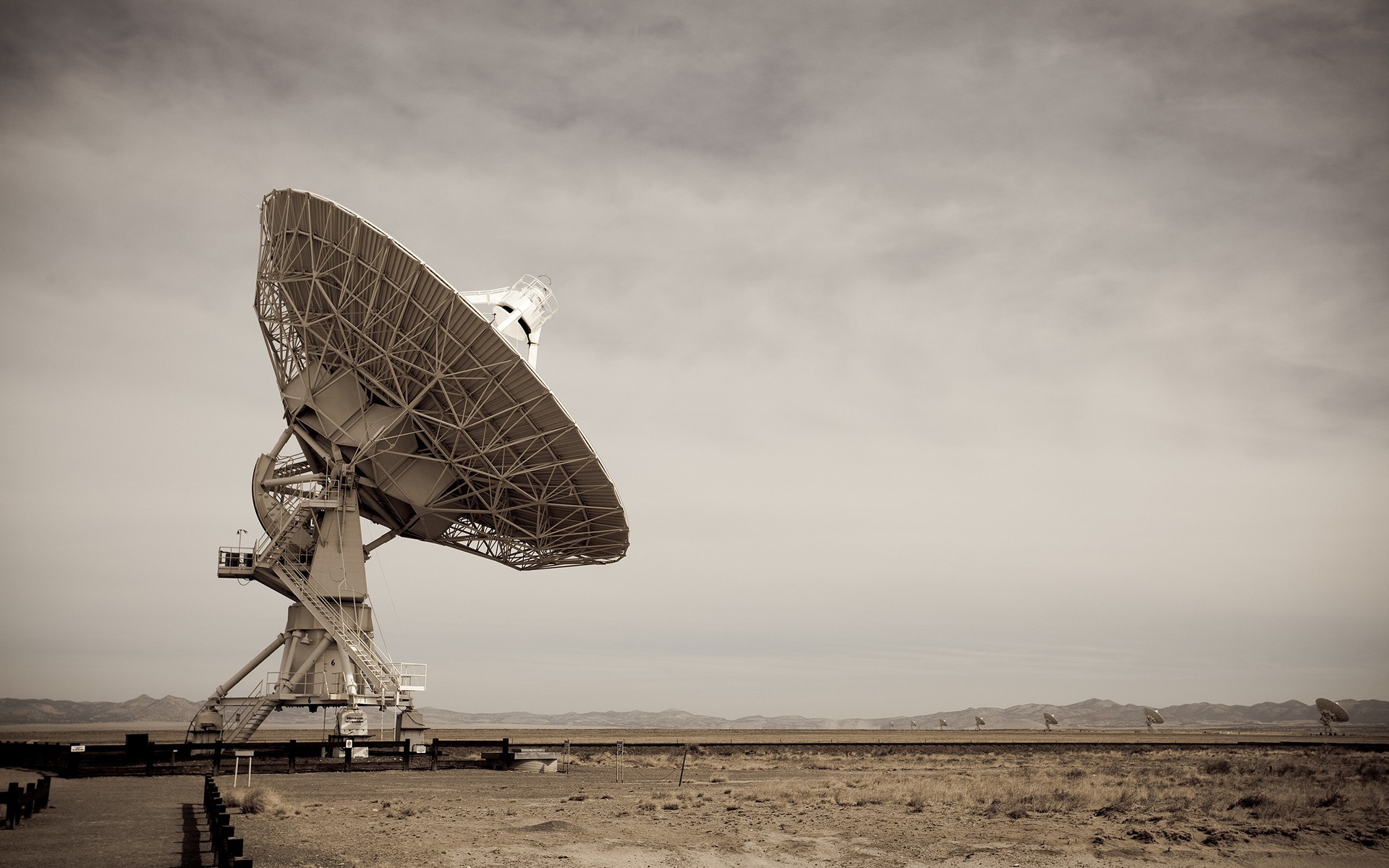 Radio telescope array in a desert landscape HD Wallpaper