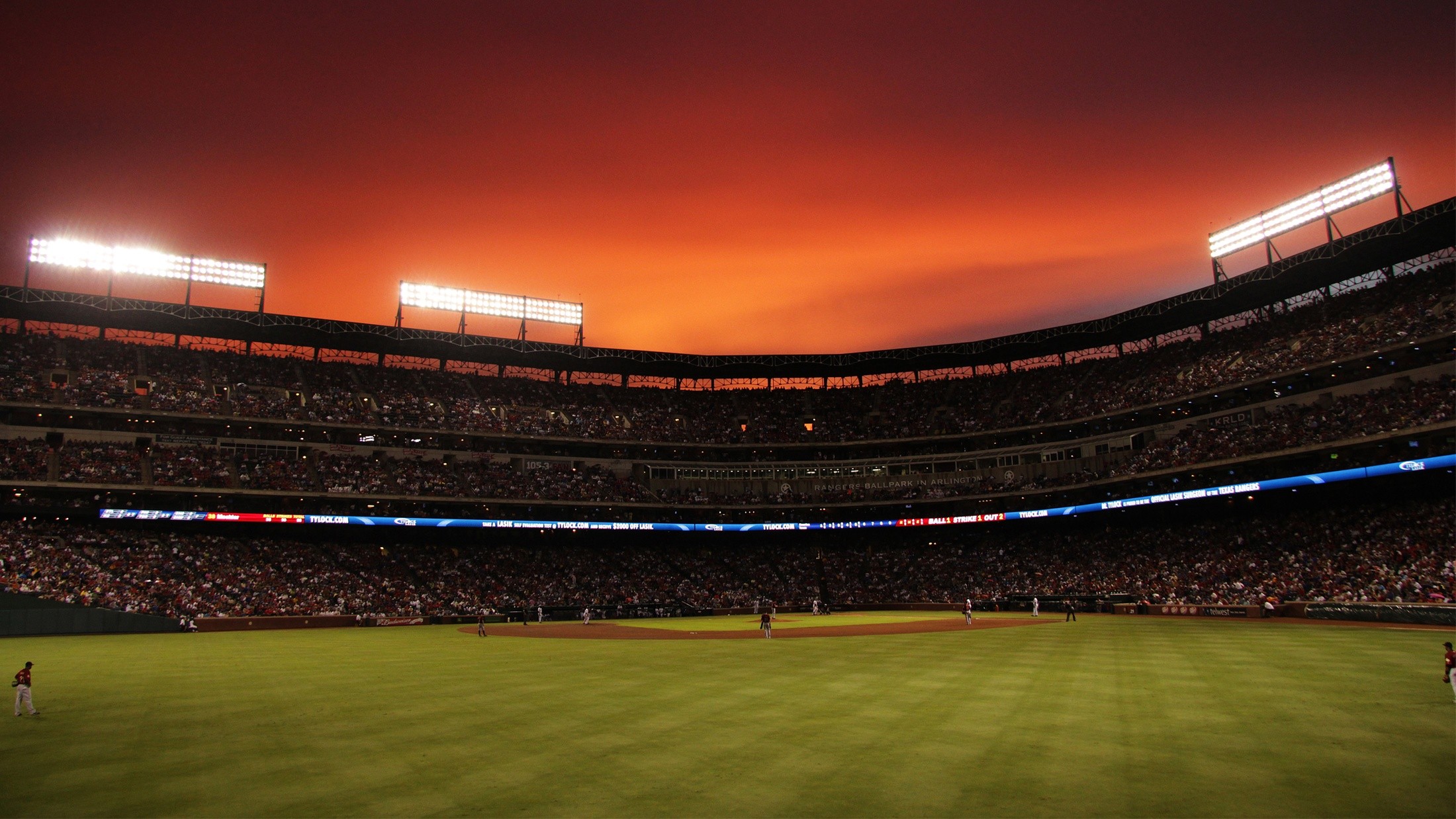 Baseball stadium at sunset with bright lights HD Wallpaper