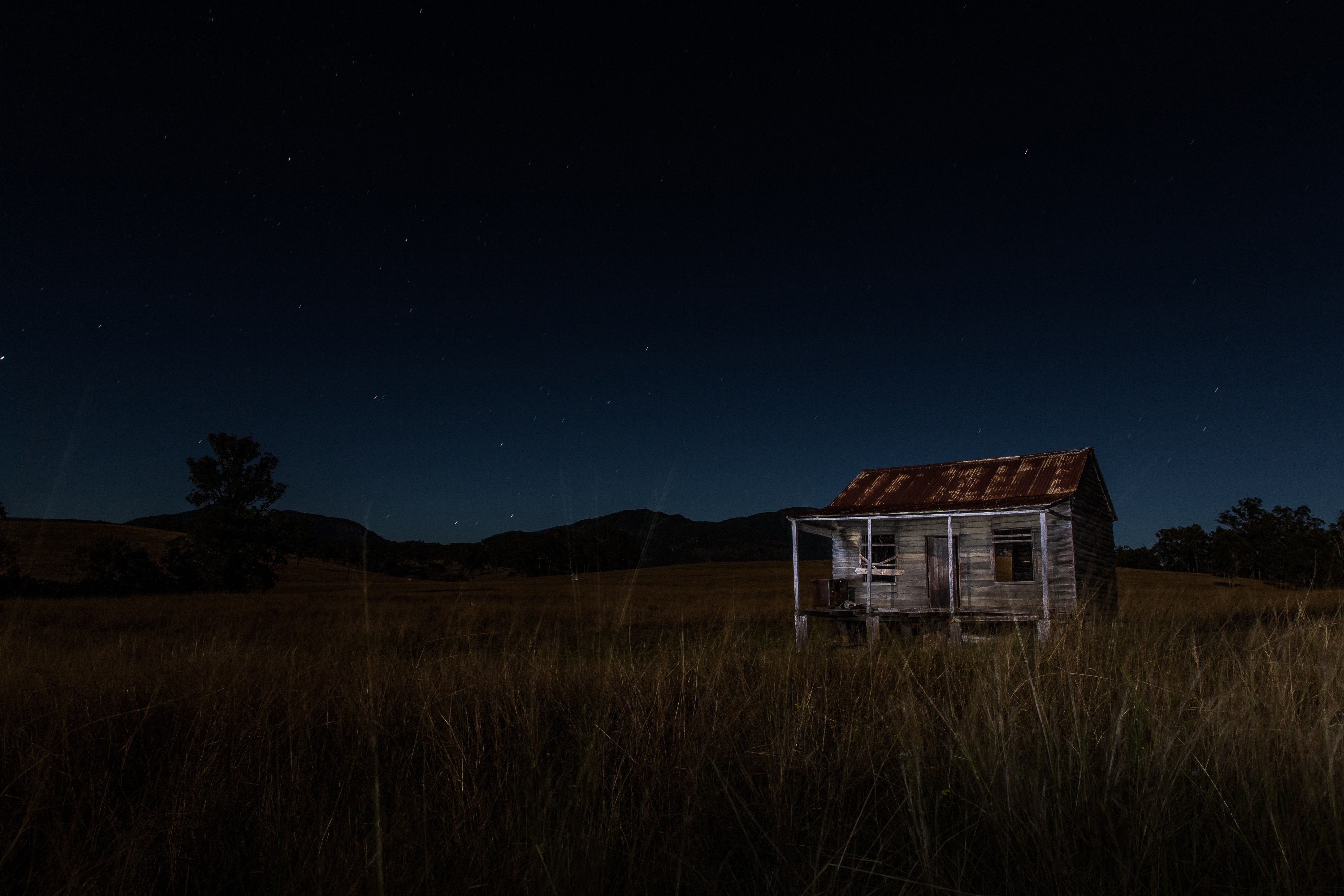 Abandoned house under a starry night sky HD Wallpaper