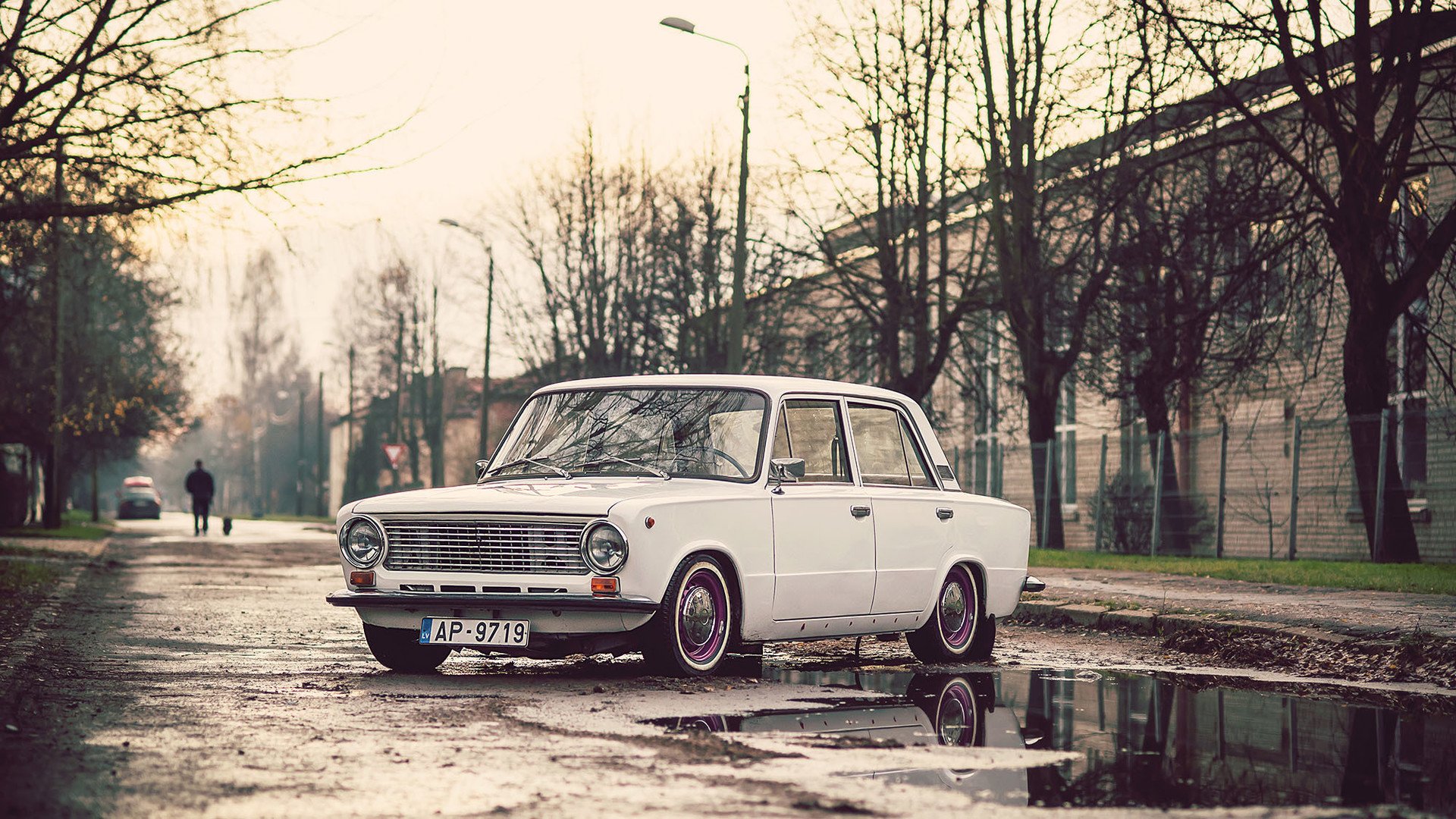 White Lada car on a wet street in Riga, Latvia HD Wallpaper