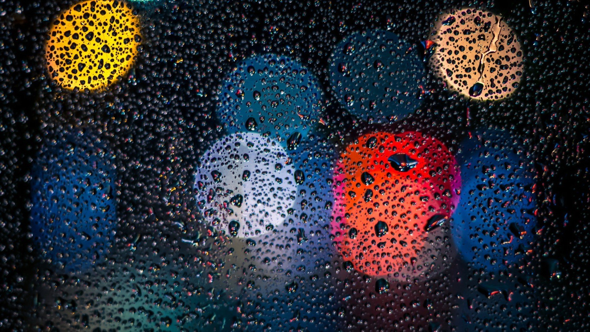 Bokeh lights through water drops on glass HD Wallpaper