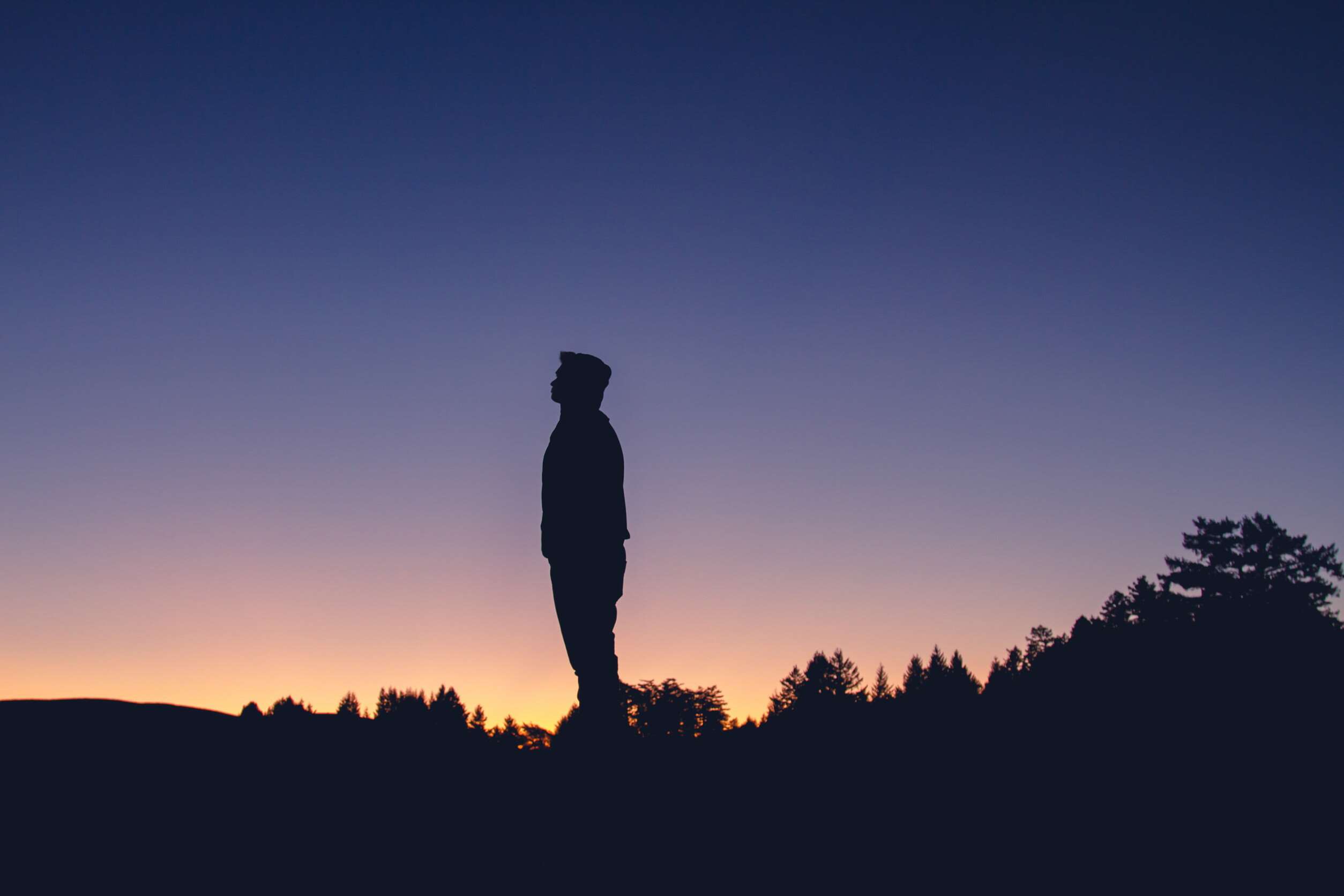 Silhouette of a man at sunset HD Wallpaper