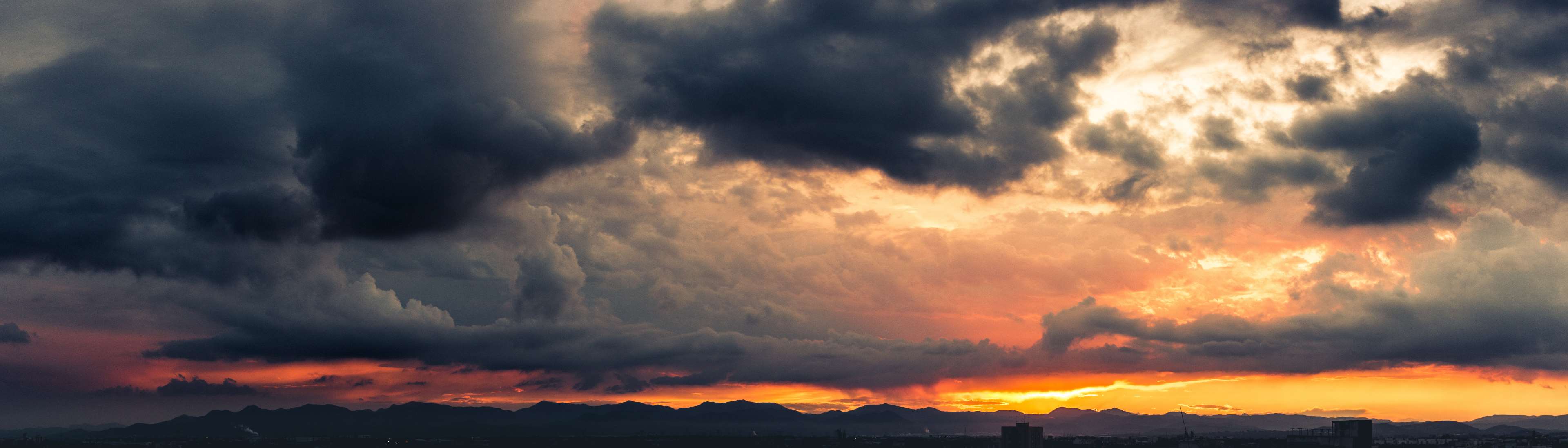 Dark storm clouds over mountains at sunset 4K HD Wallpaper