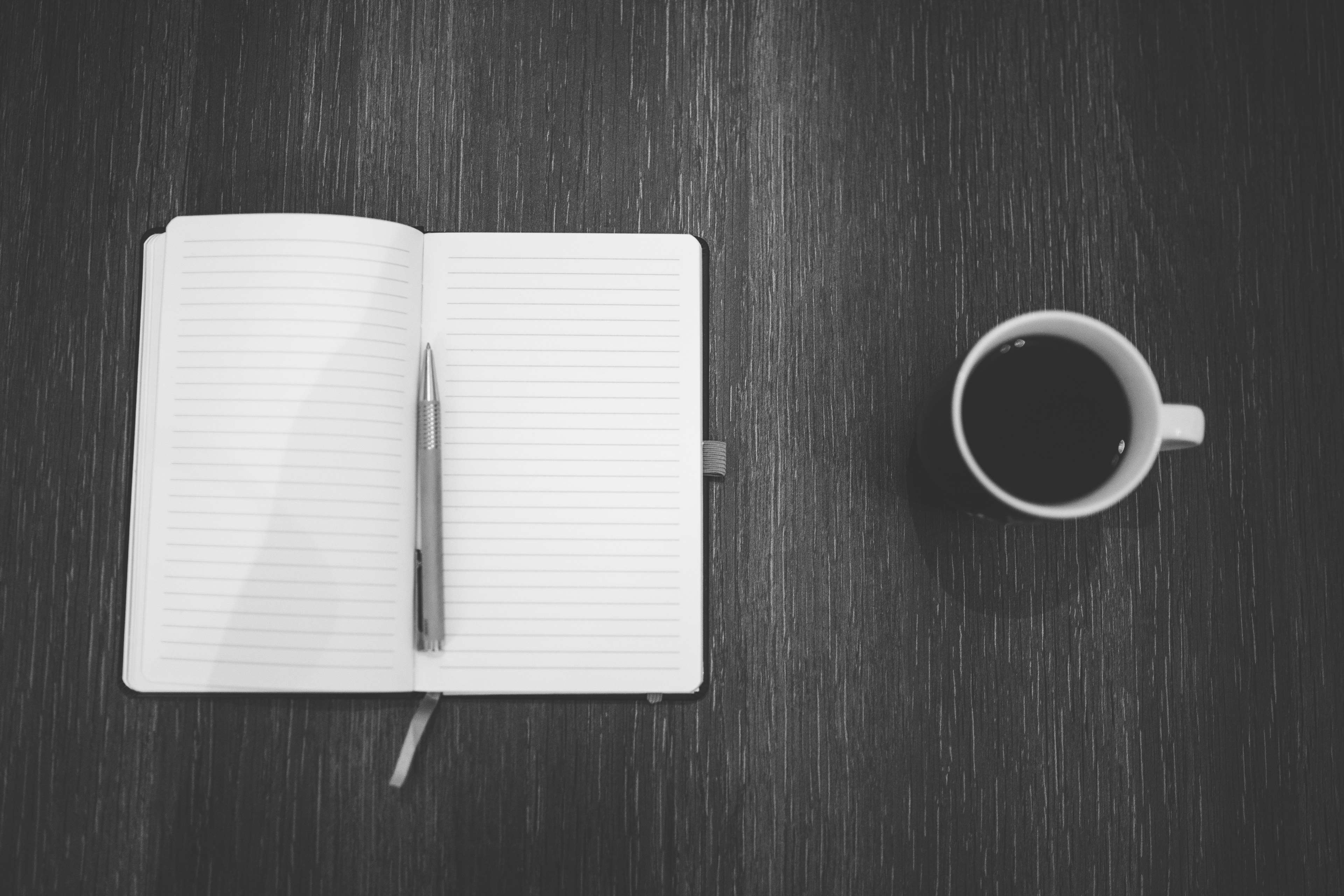 Notebook and Coffee Cup on Table 4K HD Wallpaper