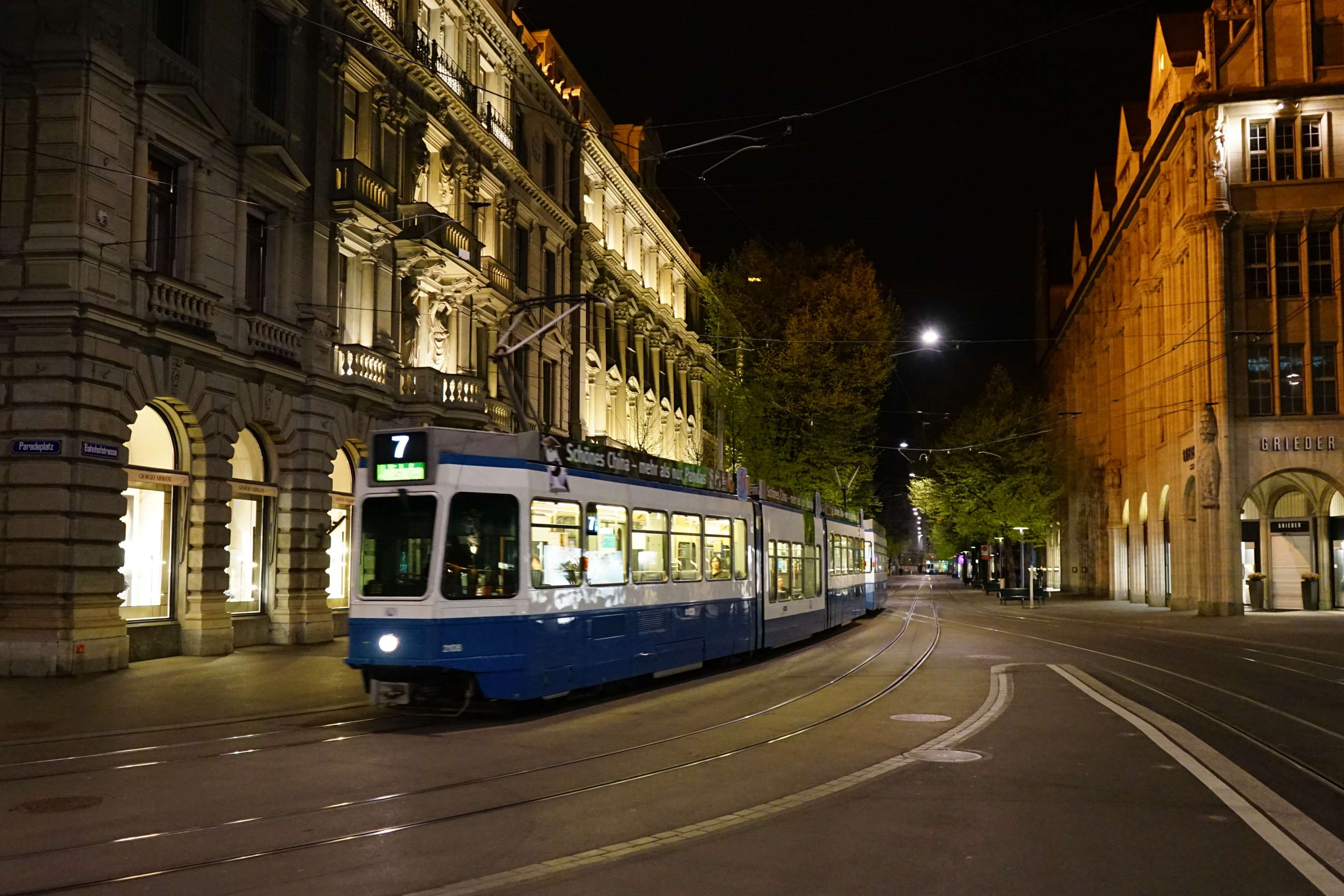 Tram 7 on a street in Zurich at night HD Wallpaper