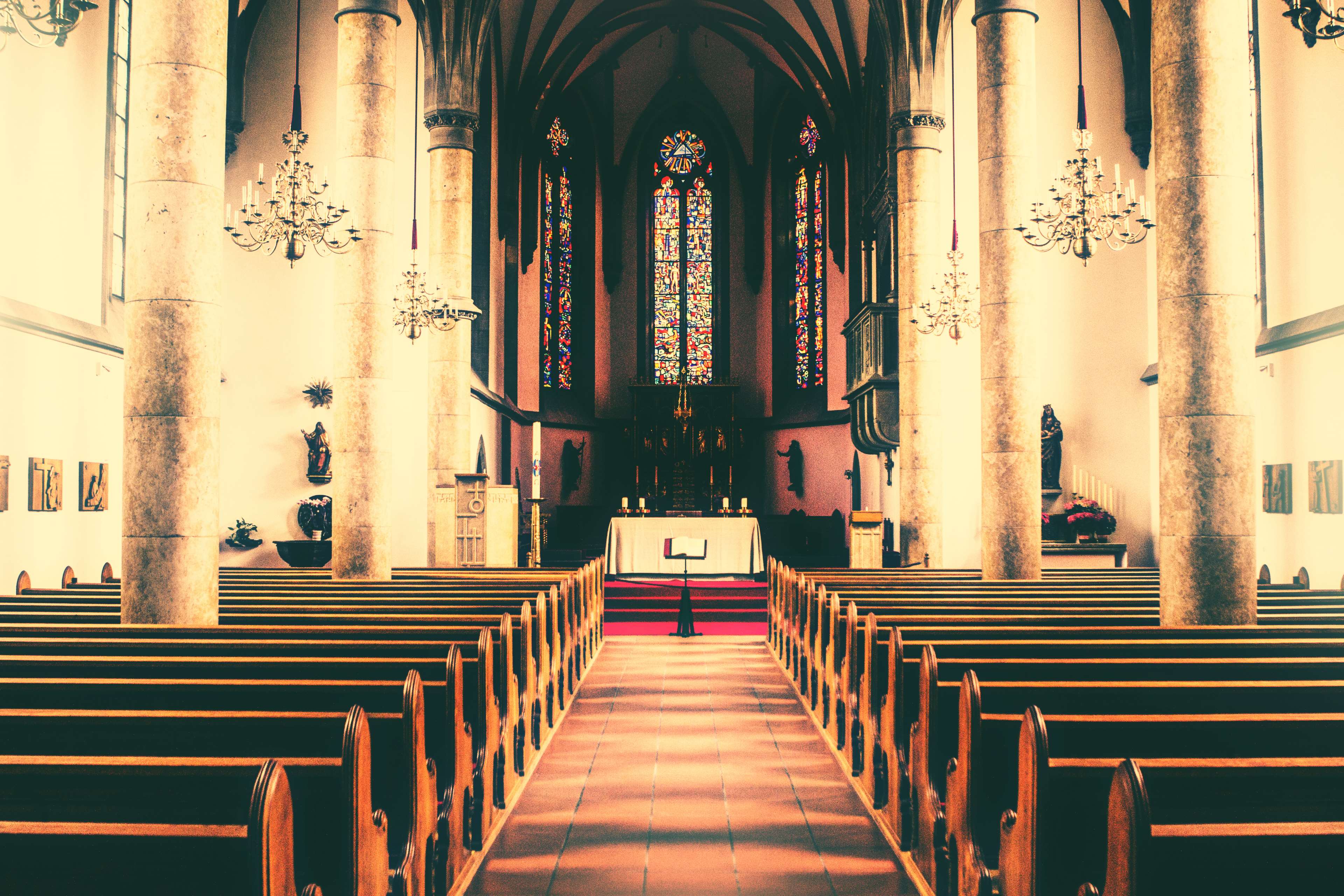 Church interior with pews and stained glass windows HD Wallpaper