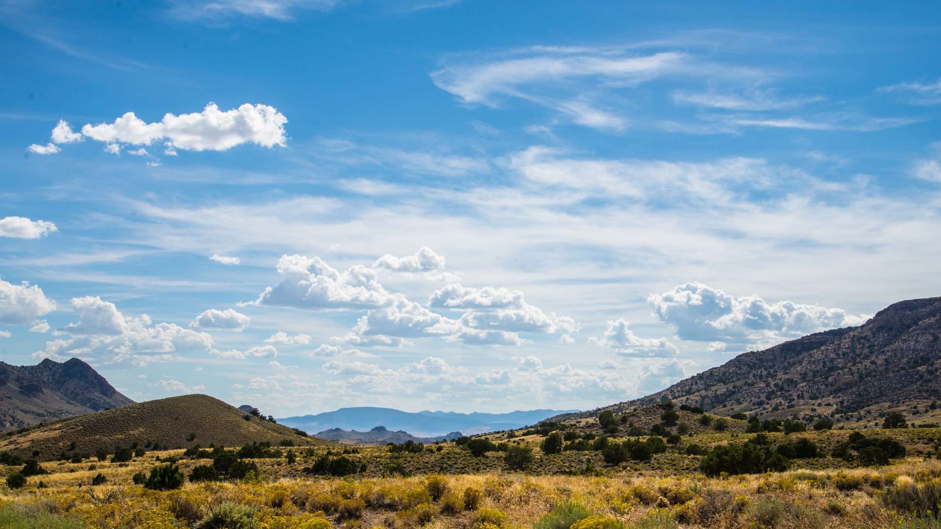 Desert hills under a blue sky with clouds HD Wallpaper