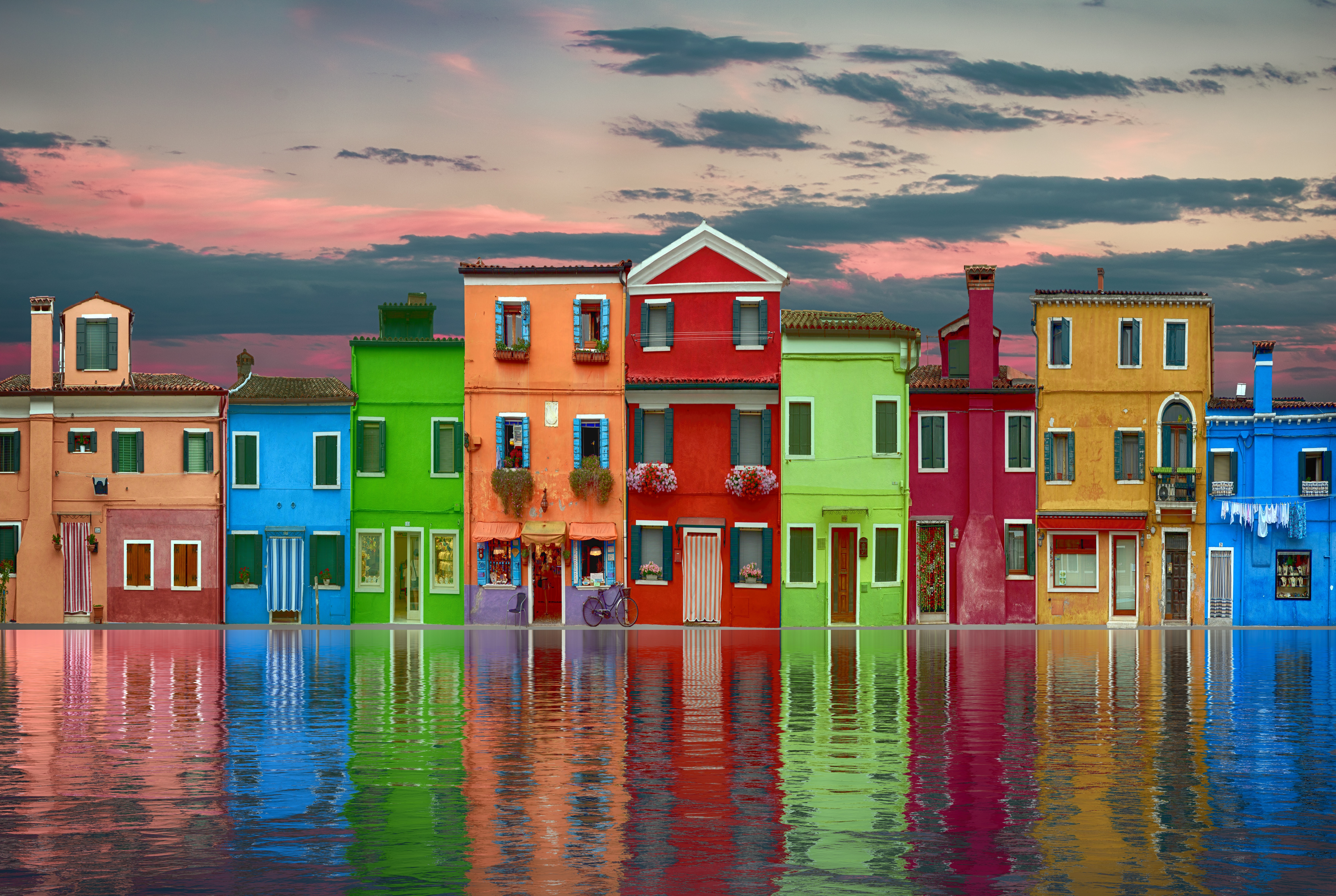 Colorful buildings reflected in water at sunset HD Wallpaper