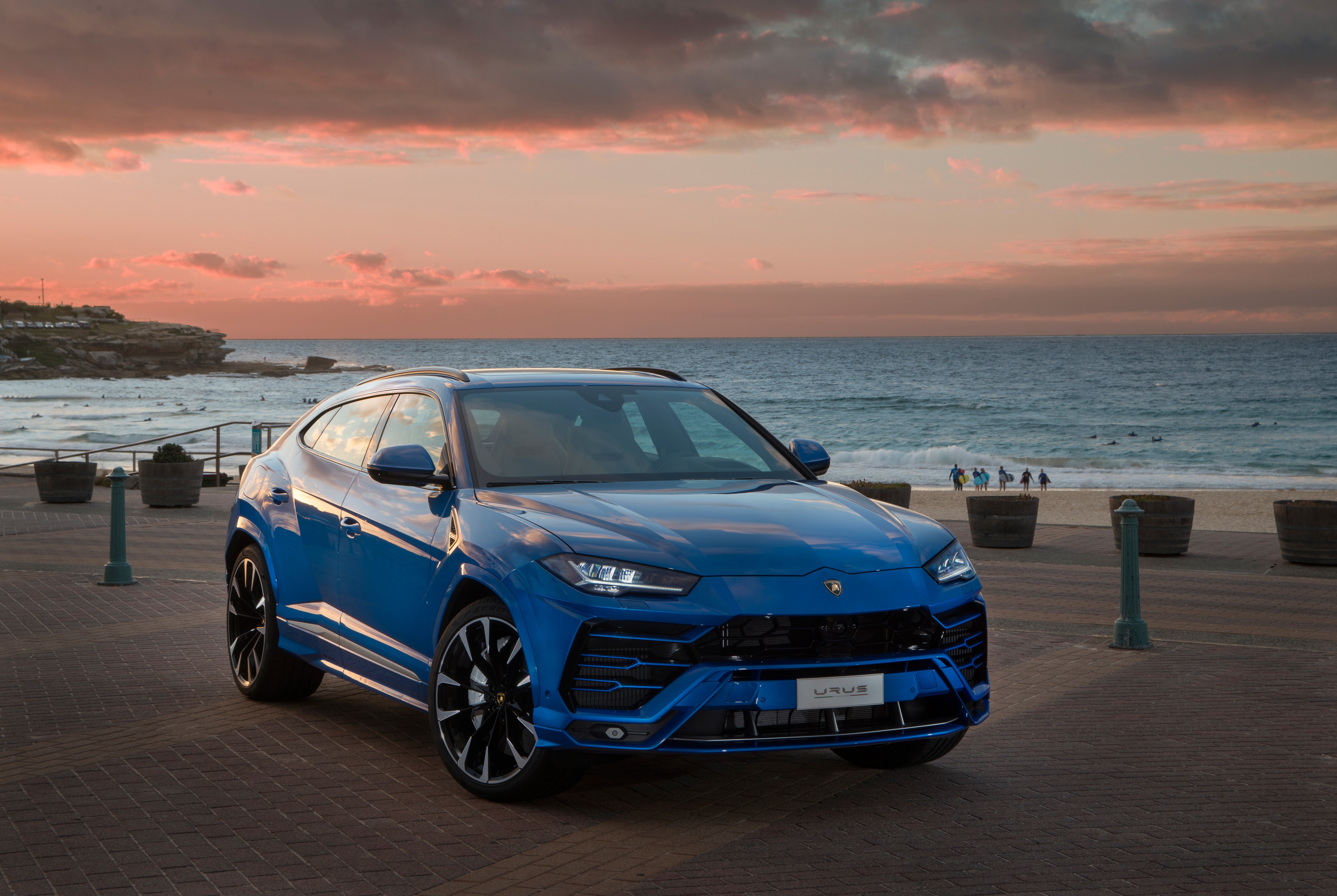 Blue Lamborghini Urus SUV on Beach Boardwalk at Sunset HD Wallpaper