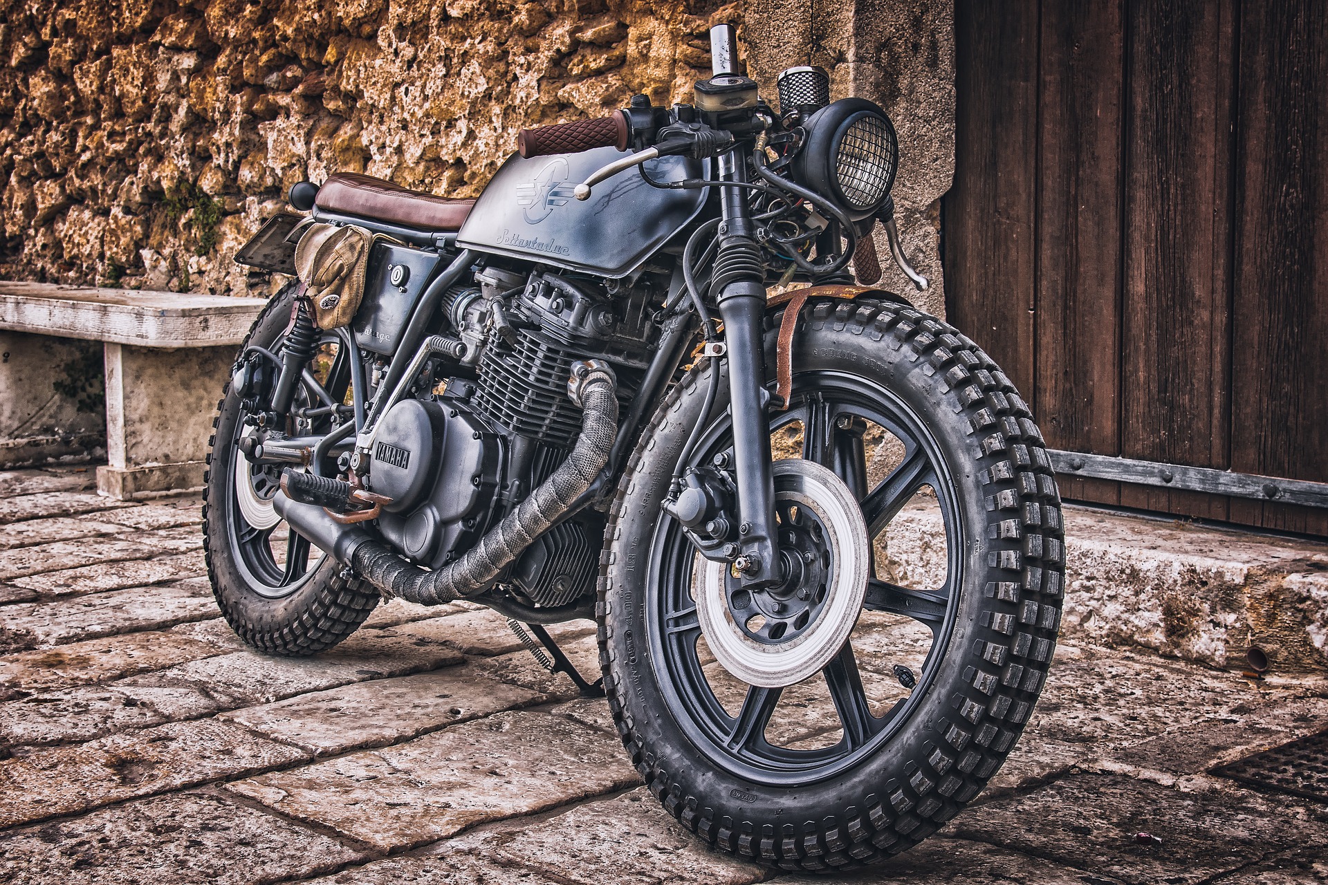 Custom Yamaha Motorcycle parked on stone patio HD Wallpaper