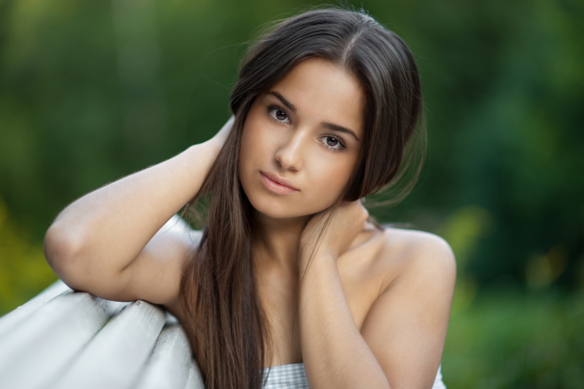 Woman with long brown hair on a bench HD Wallpaper