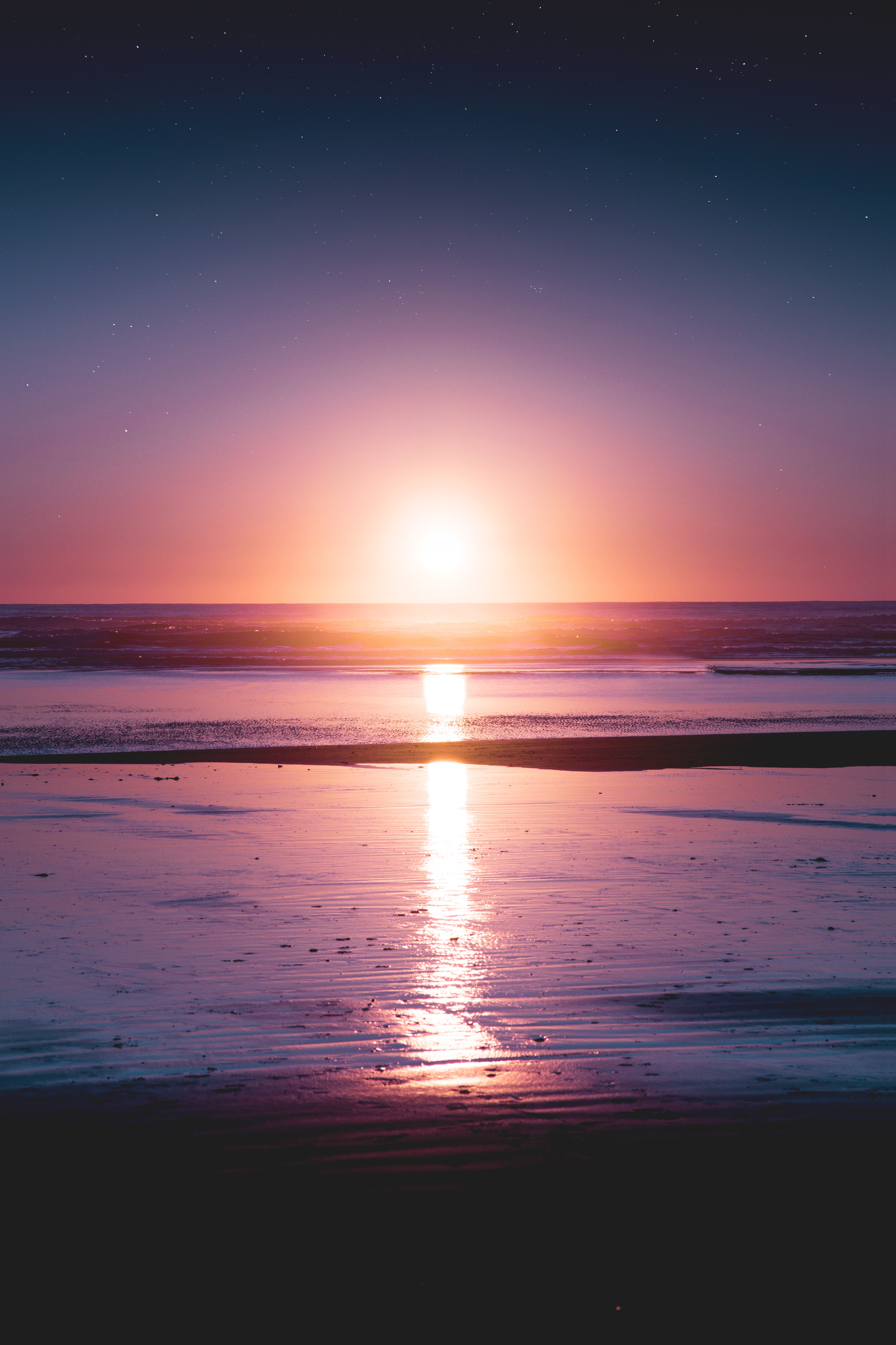 Sunset over the ocean with beach and stars HD Wallpaper
