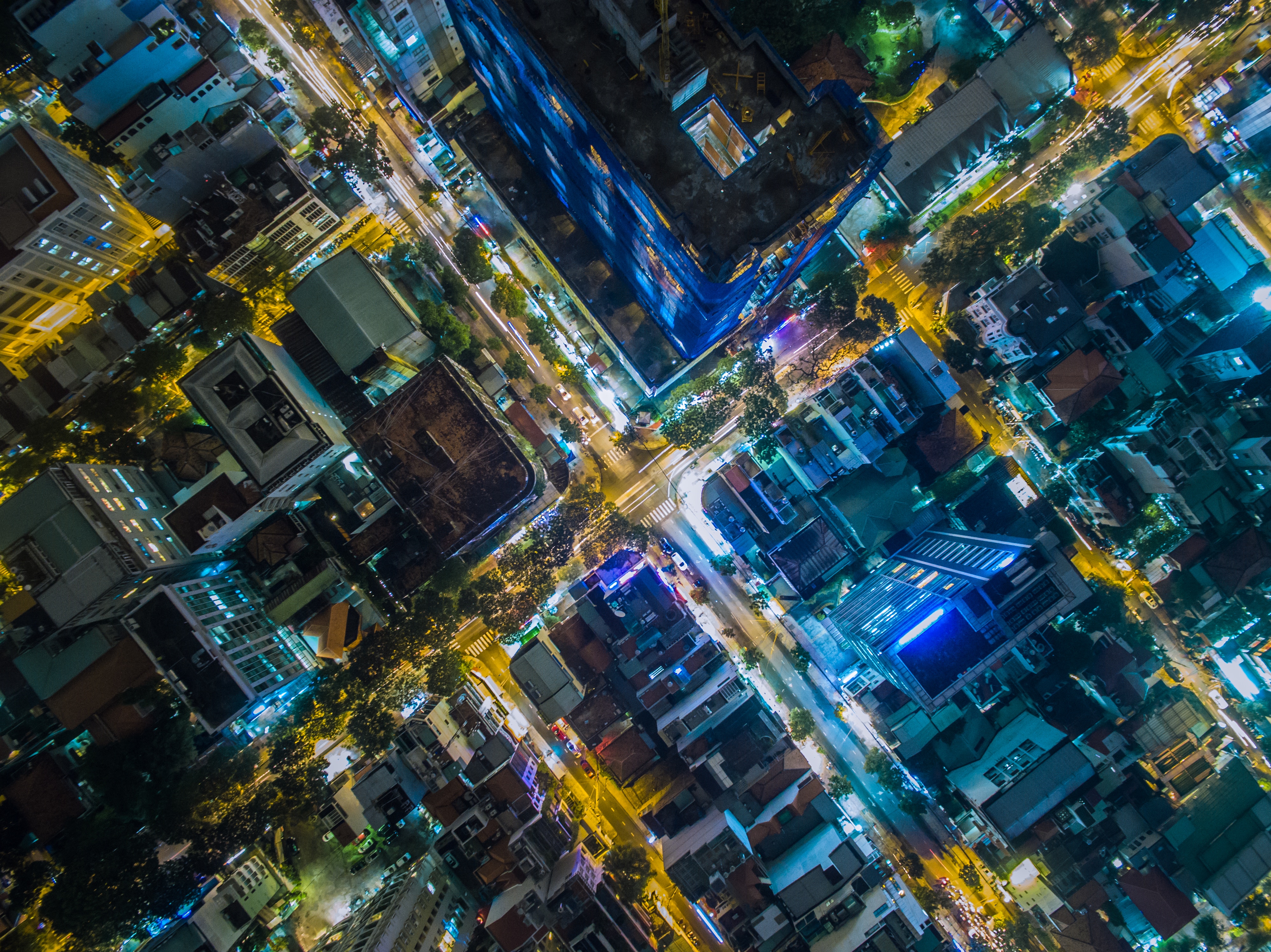 Aerial view of a busy city intersection at night HD Wallpaper