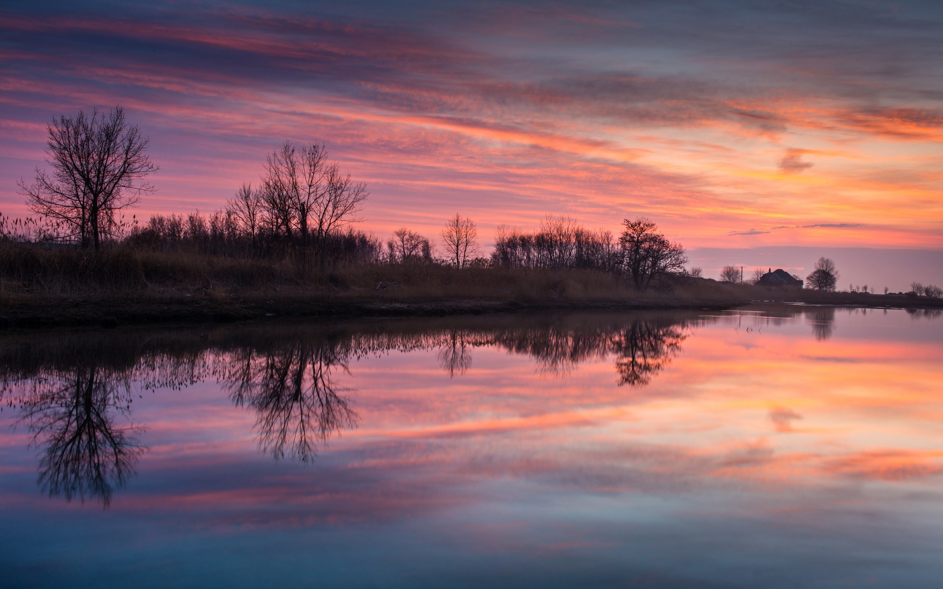 Sunset over a calm lake with reflections HD Wallpaper
