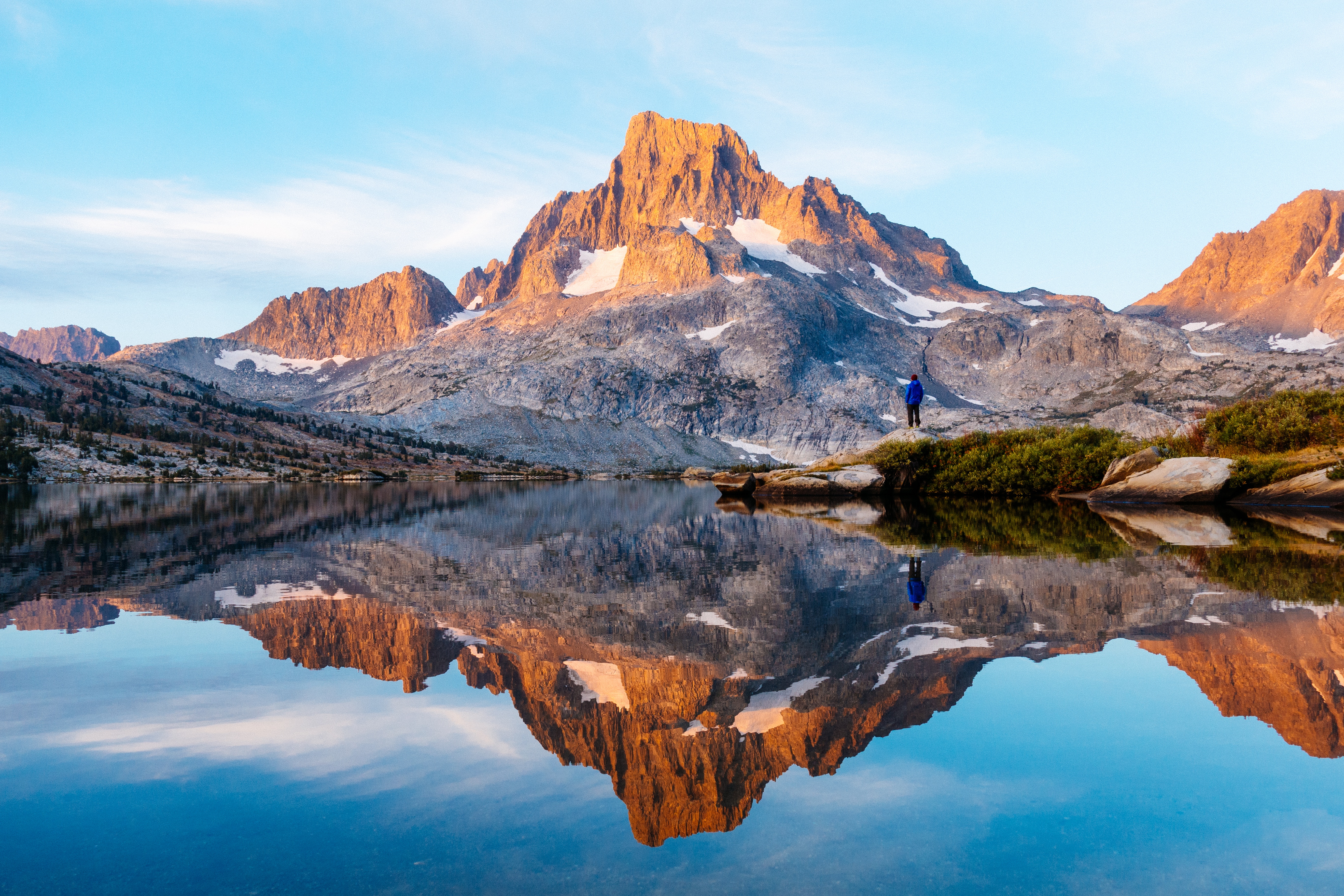 Person overlooking Thousand Island Lake with mountain reflection HD Wallpaper