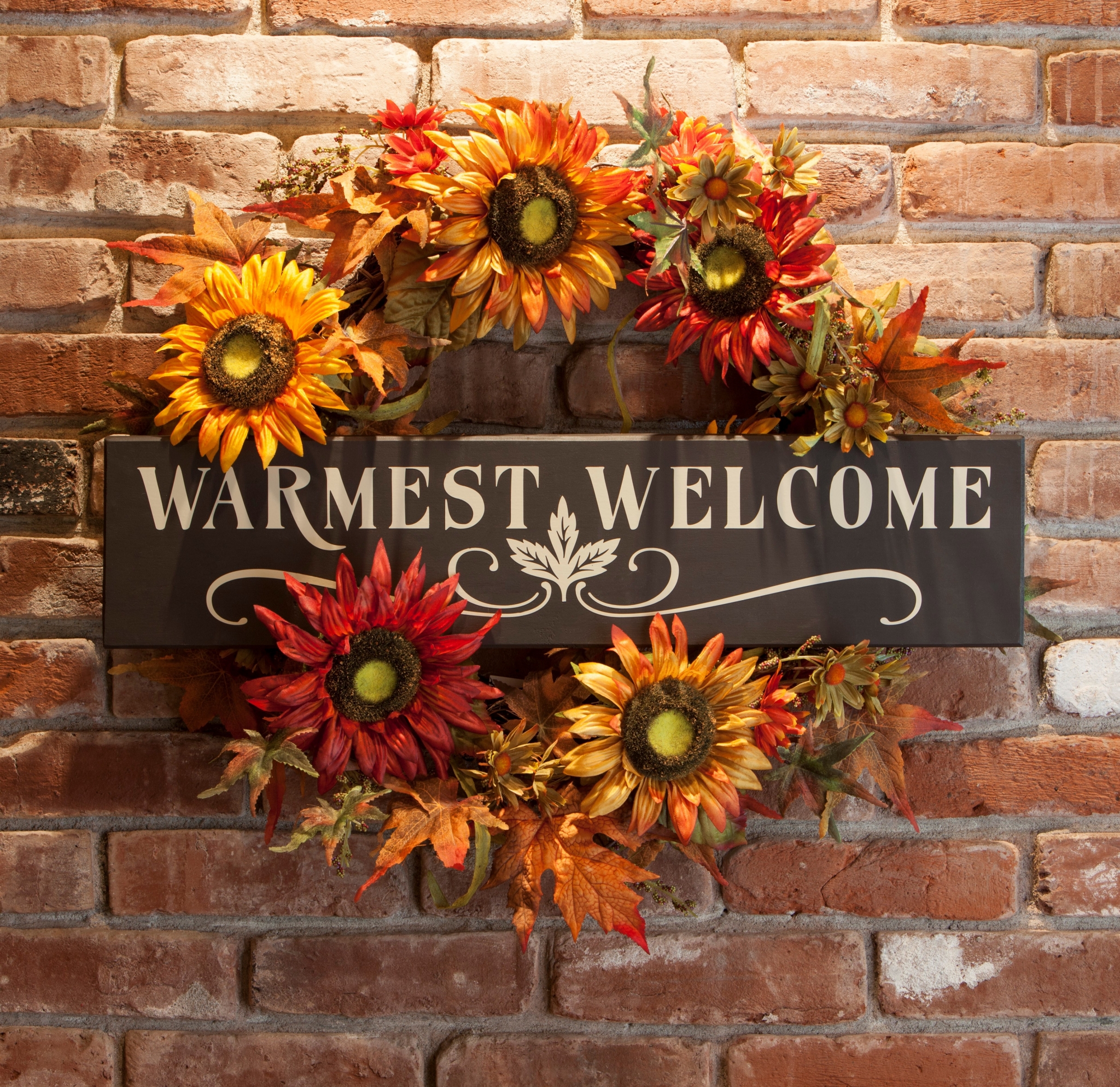 Fall wreath with "Warmest Welcome" sign on brick wall HD Wallpaper