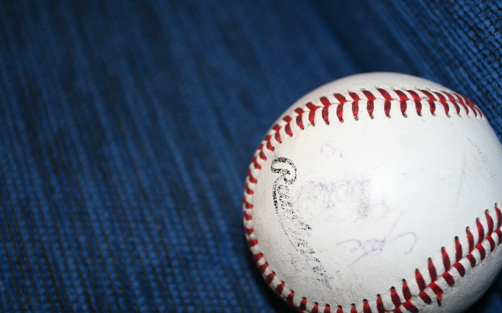 Autographed baseball on blue textured surface HD Wallpaper