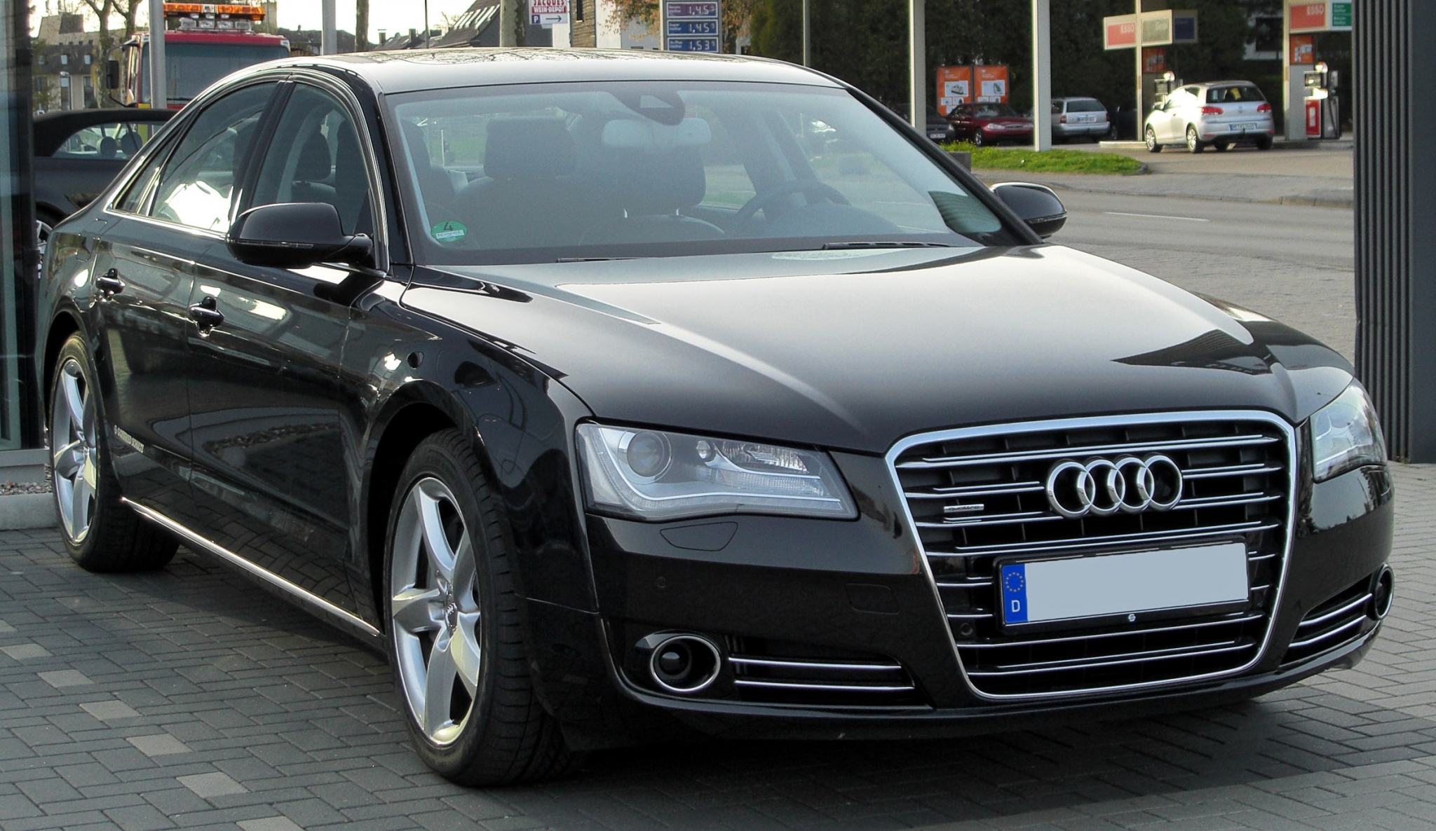 Black Audi A8 parked on brick pavement HD Wallpaper