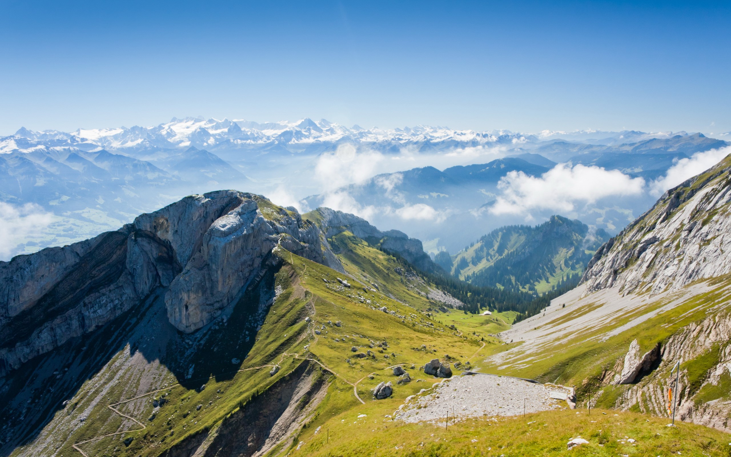 Mountain range with snow-capped peaks and clouds HD Wallpaper
