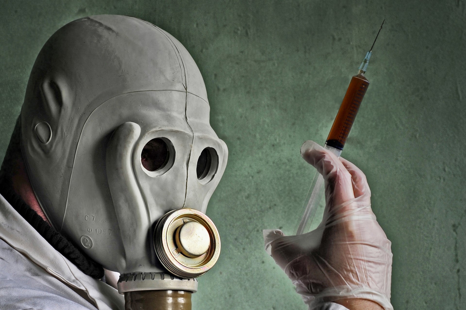 Person in gas mask holding syringe HD Wallpaper