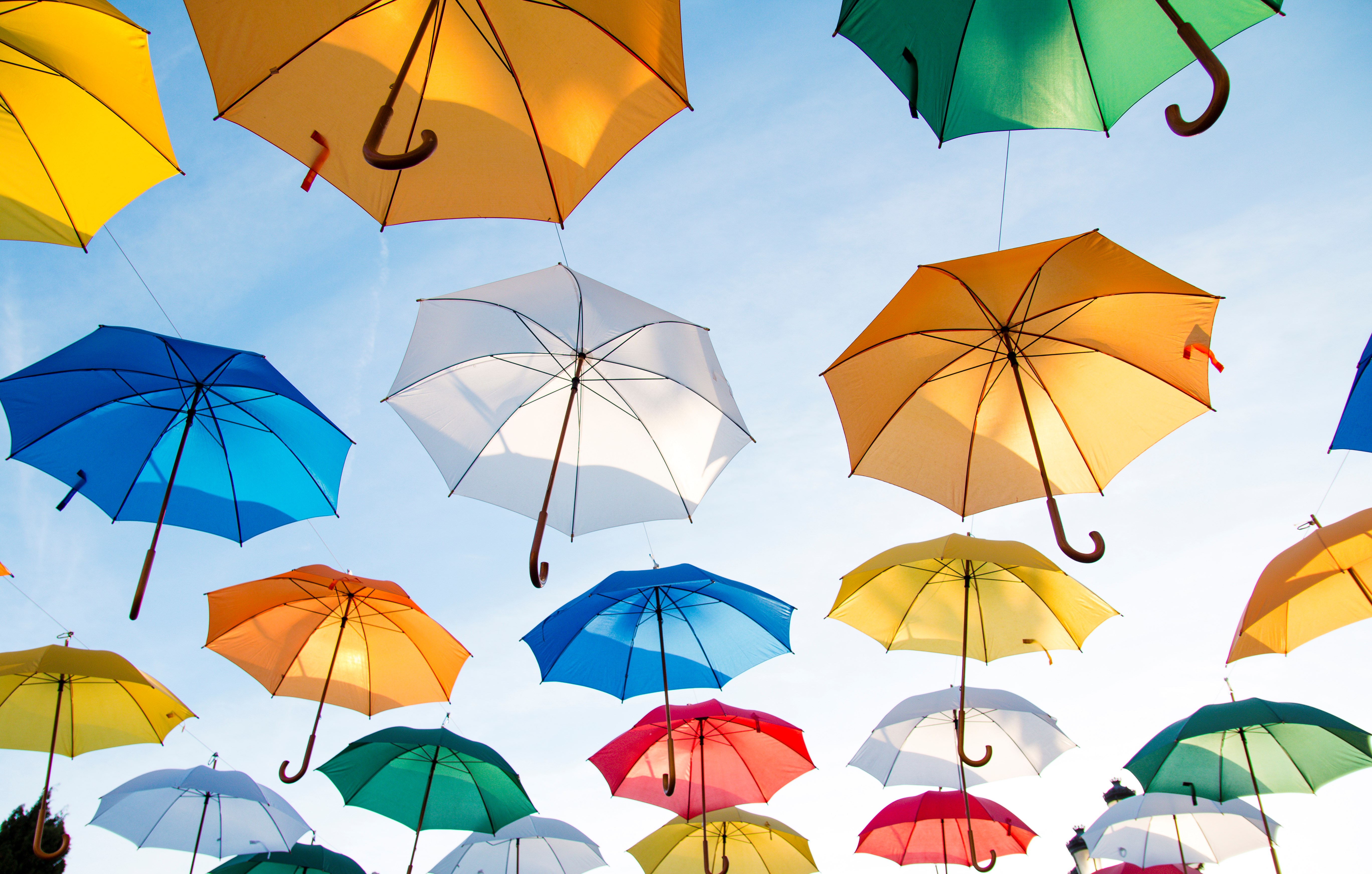Colorful umbrellas suspended in the sky HD Wallpaper