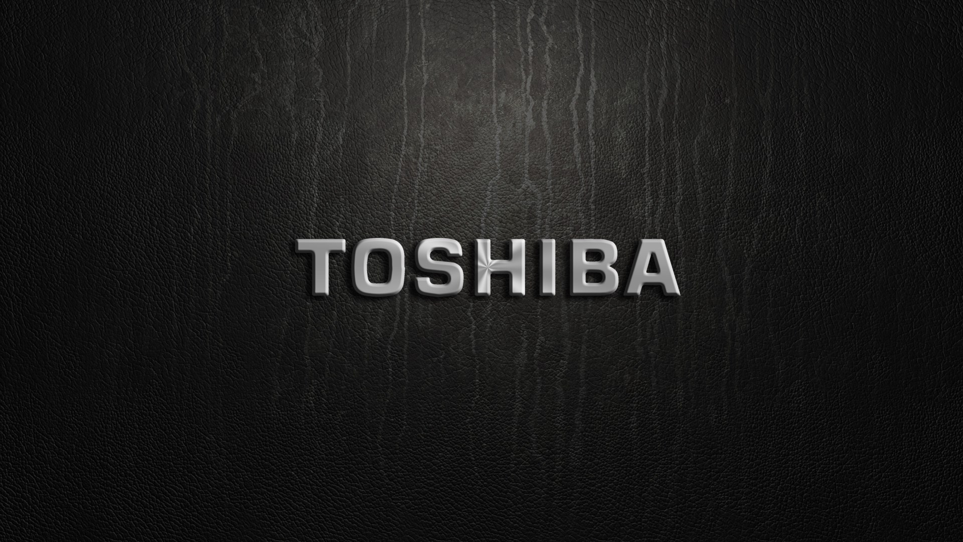 Toshiba logo on a textured black background HD Wallpaper