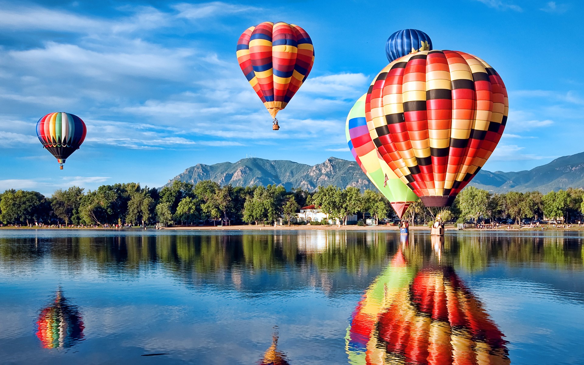 Hot air balloons over a lake with mountains HD Wallpaper
