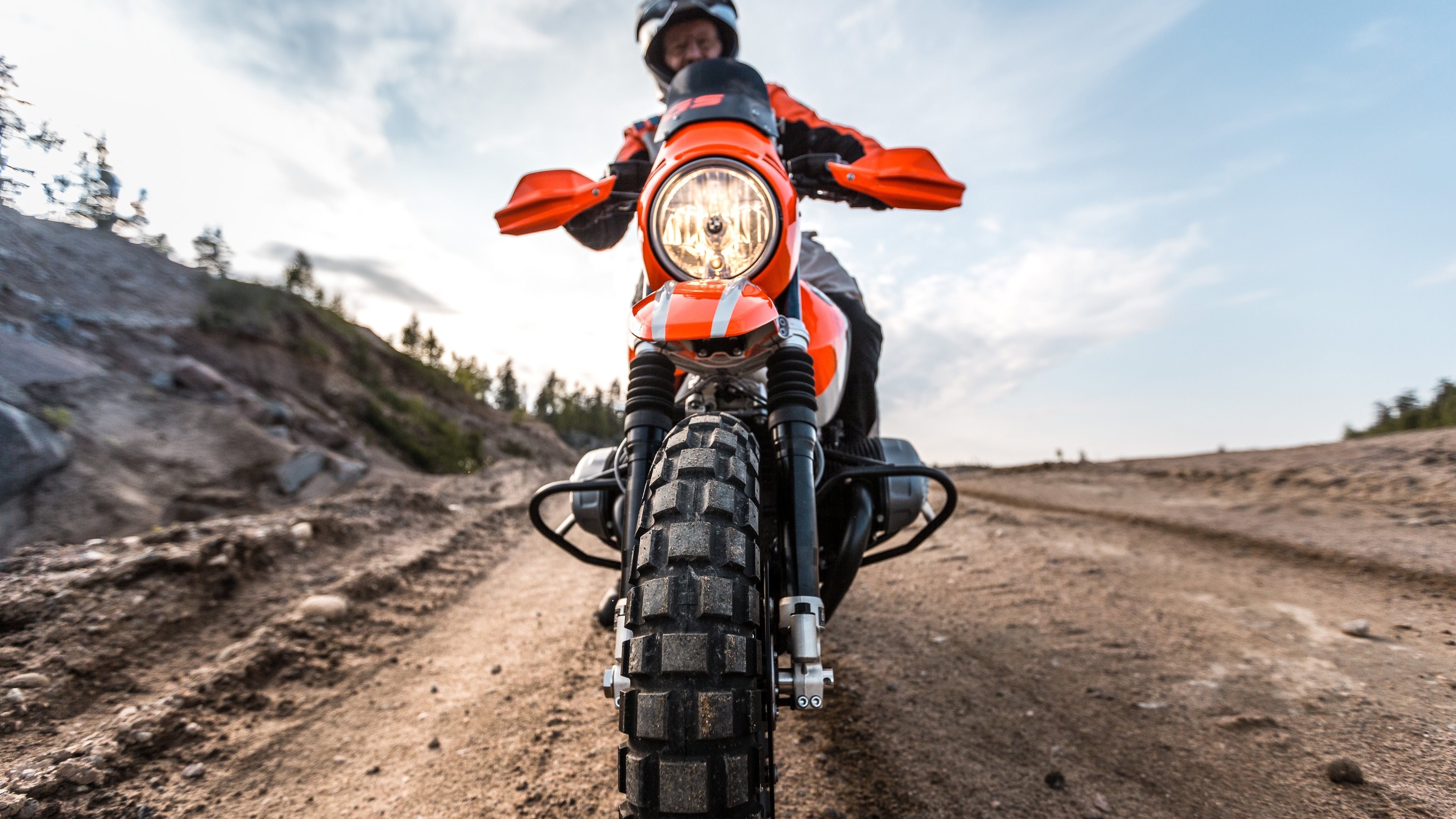 Motorcyclist on a dirt road HD Wallpaper