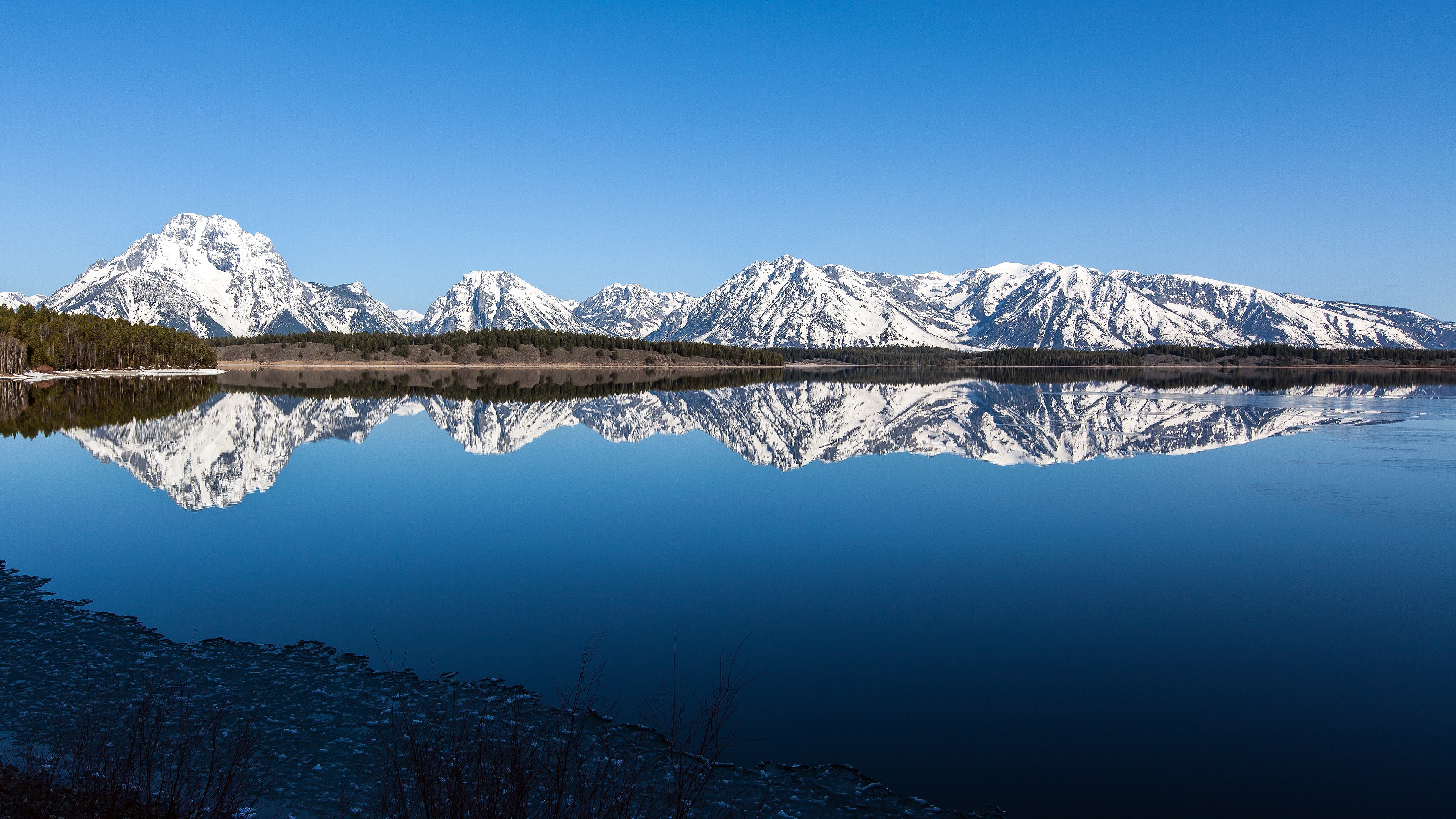 Snow-capped mountains reflected in a lake HD Wallpaper