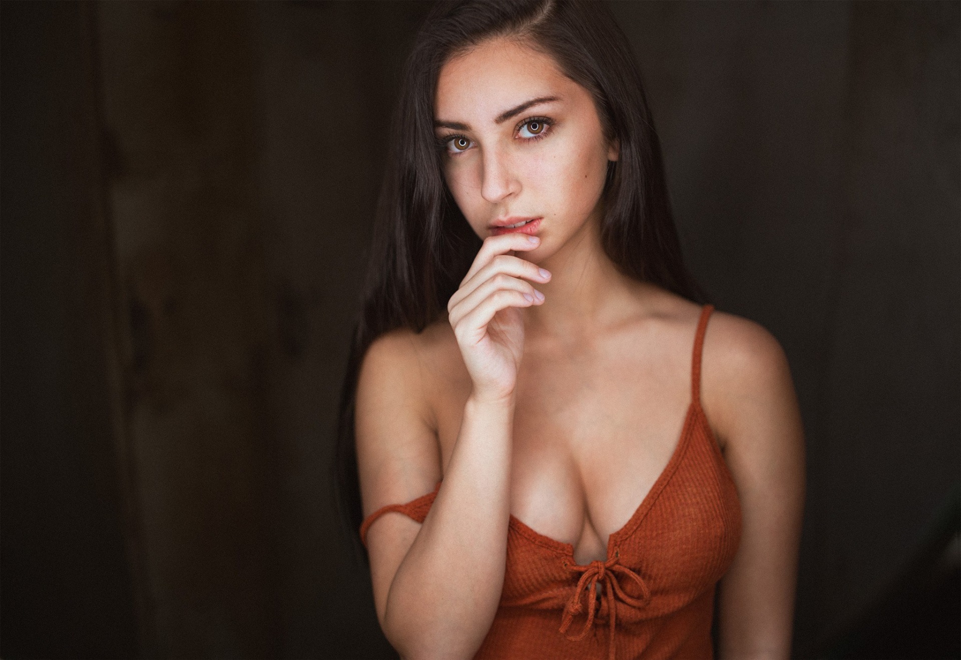 Young woman with dark hair in a rust-colored top HD Wallpaper