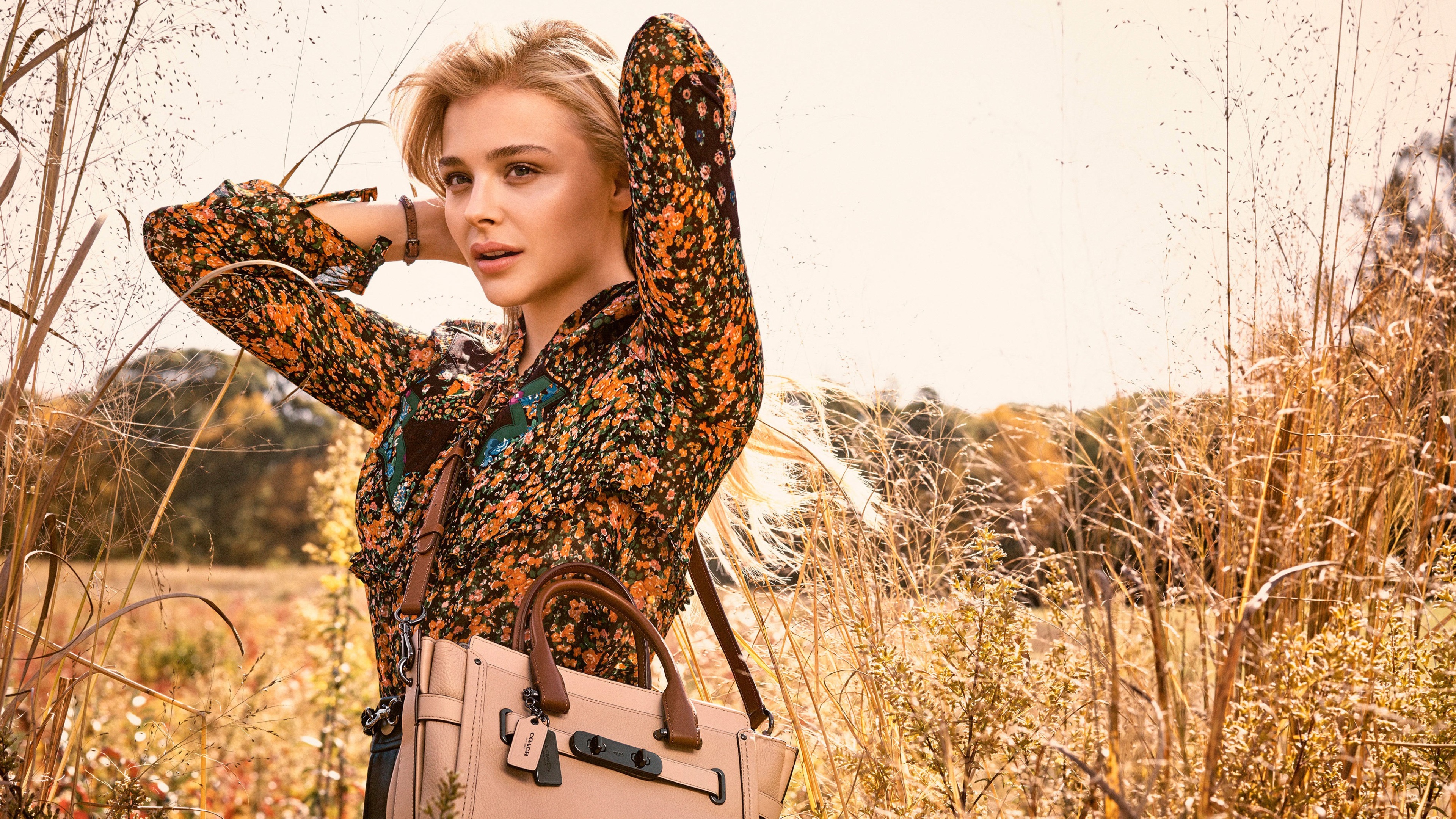 Chloe Grace Moretz in a floral dress with a Coach bag HD Wallpaper